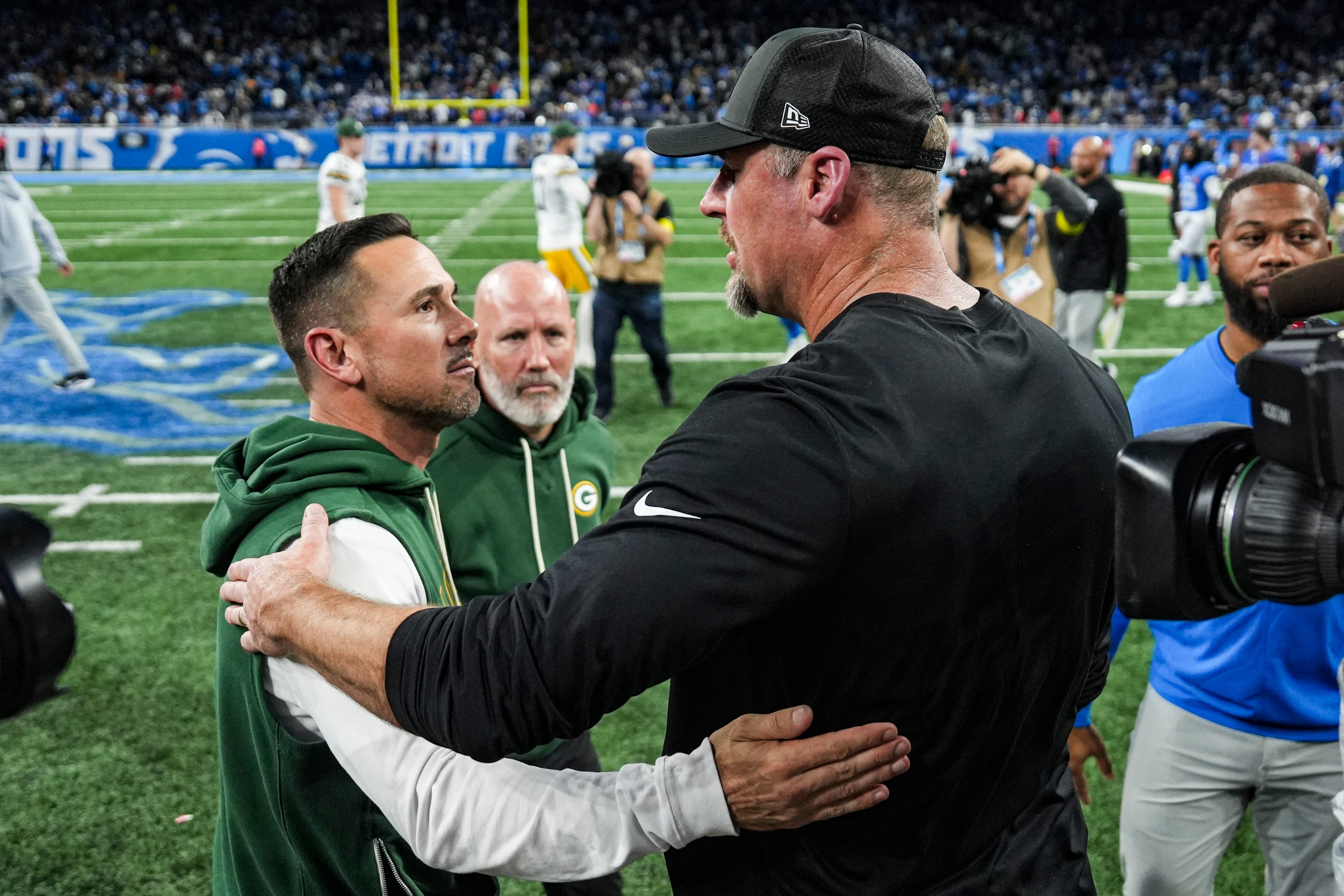 Detroit Lions head coach Dan Campbell, right, shakes hands with Green Bay Packers head coach Matt LaFleur after 31-24 loss at Ford Field in Detroit on Thursday, Nov. 27, 2025.