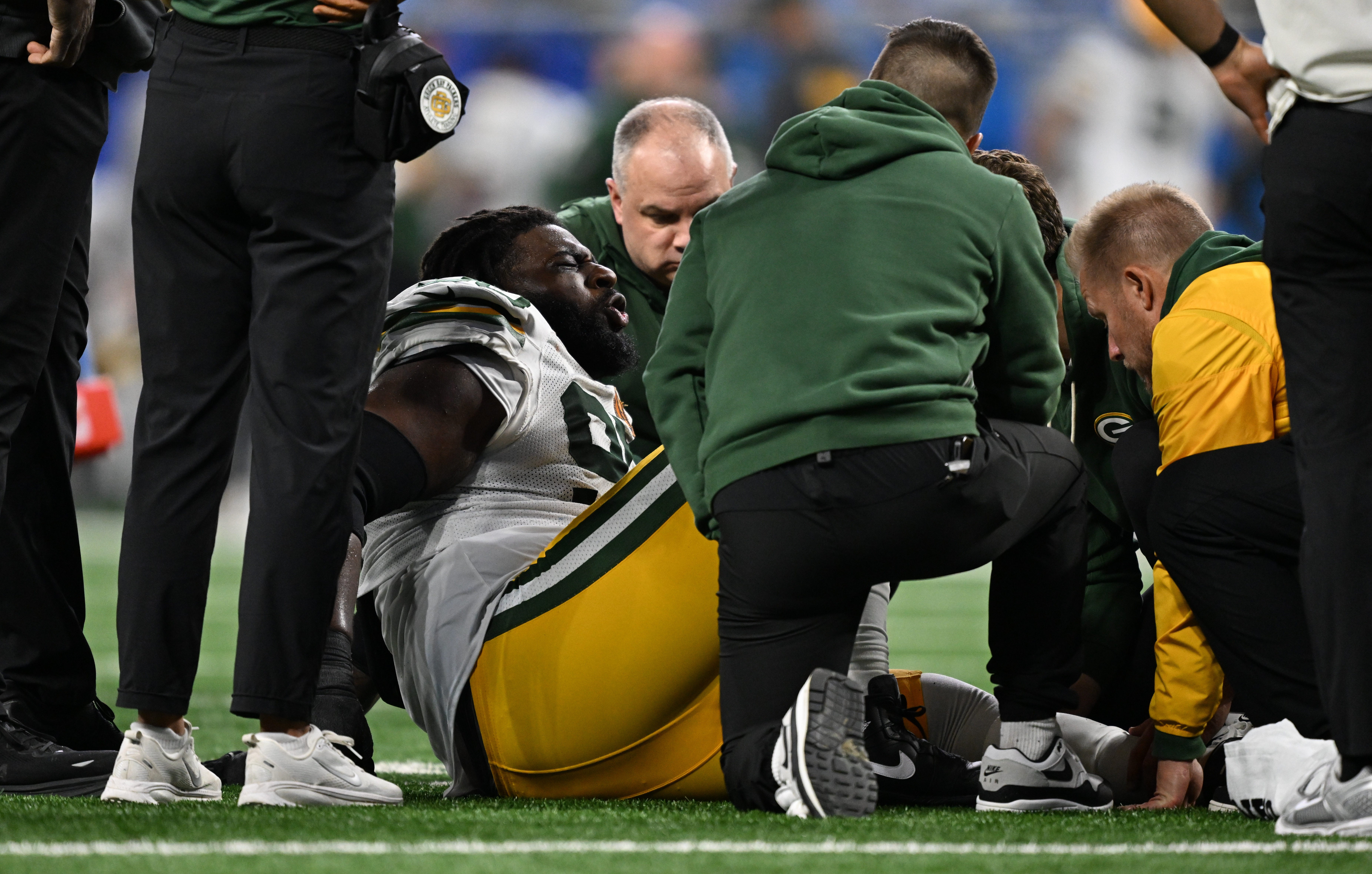 Nov 27, 2025; Detroit, Michigan, USA; Green Bay Packers defensive tackle Devonte Wyatt (95) is looked at after an injury against the Detroit Lions during the third quarter at Ford Field.