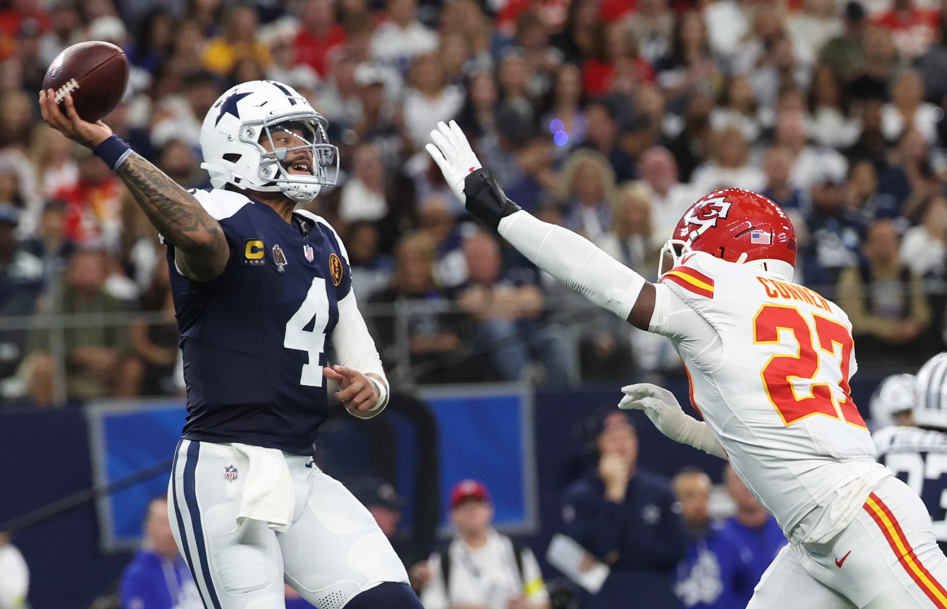 Nov 27, 2025; Arlington, Texas, USA; Dallas Cowboys quarterback Dak Prescott (4) throws a pass against Kansas City Chiefs safety Chamarri Conner (27) during the first quarter at AT&T Stadium.