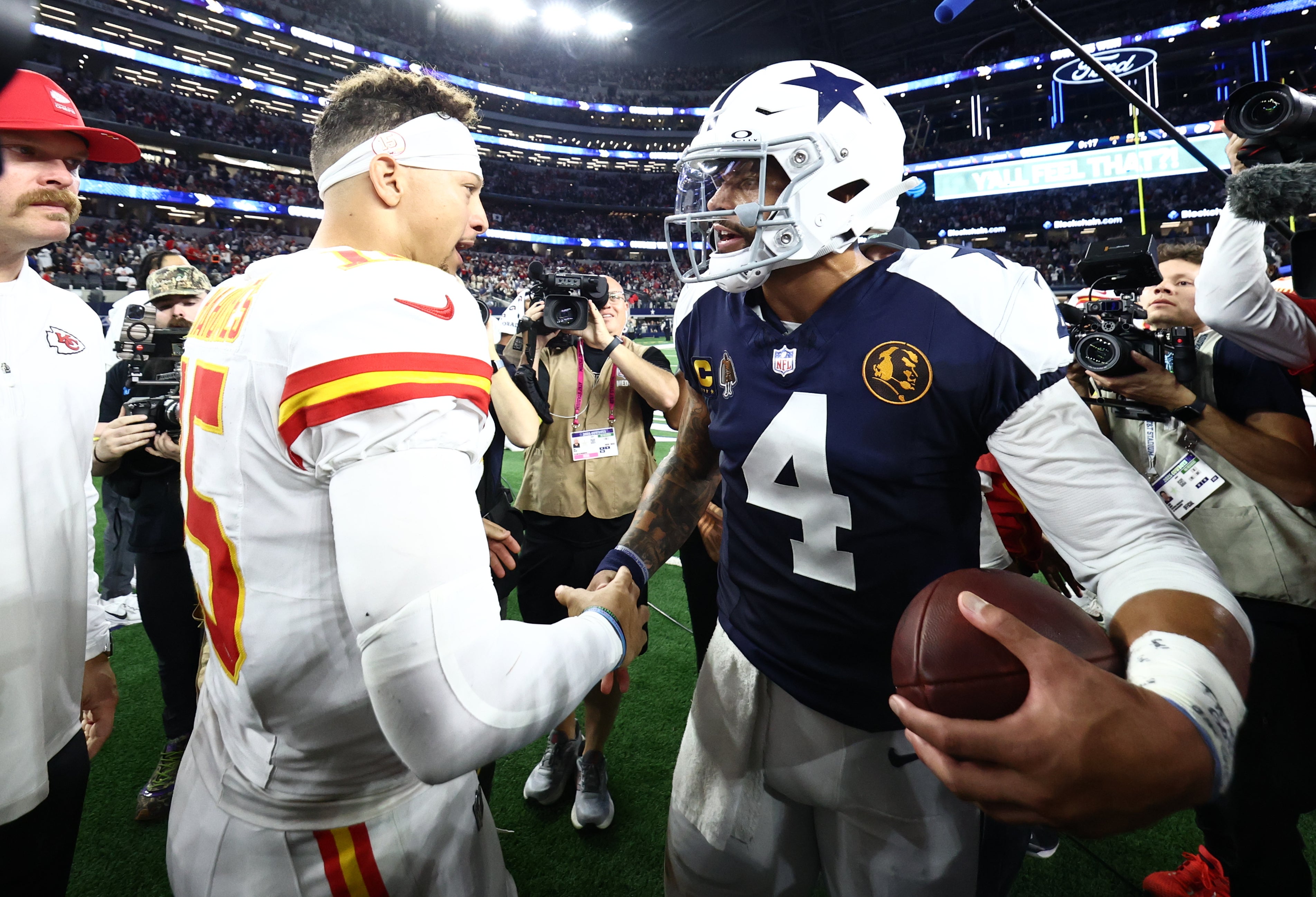 Nov 27, 2025; Arlington, Texas, USA; Kansas City Chiefs quarterback Patrick Mahomes (15) and Dallas Cowboys quarterback Dak Prescott (4) greet each other after the game at AT&T Stadium.