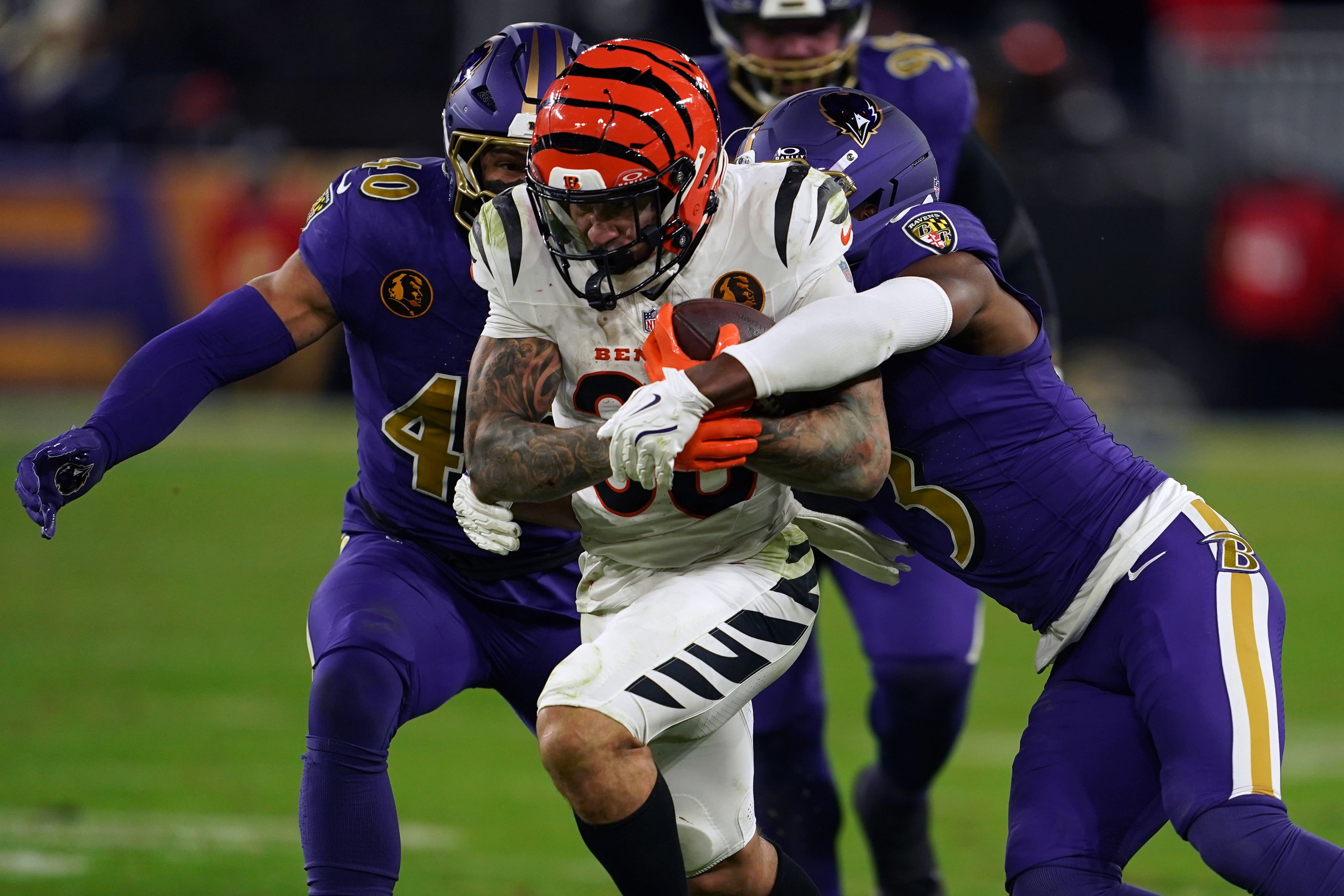 Nov 27, 2025; Baltimore, Maryland, USA; Cincinnati Bengals running back Chase Brown (30) rushed the ball against Baltimore Ravens cornerback Chidobe Awuzie (3) during the second half at M&T Bank Stadium.