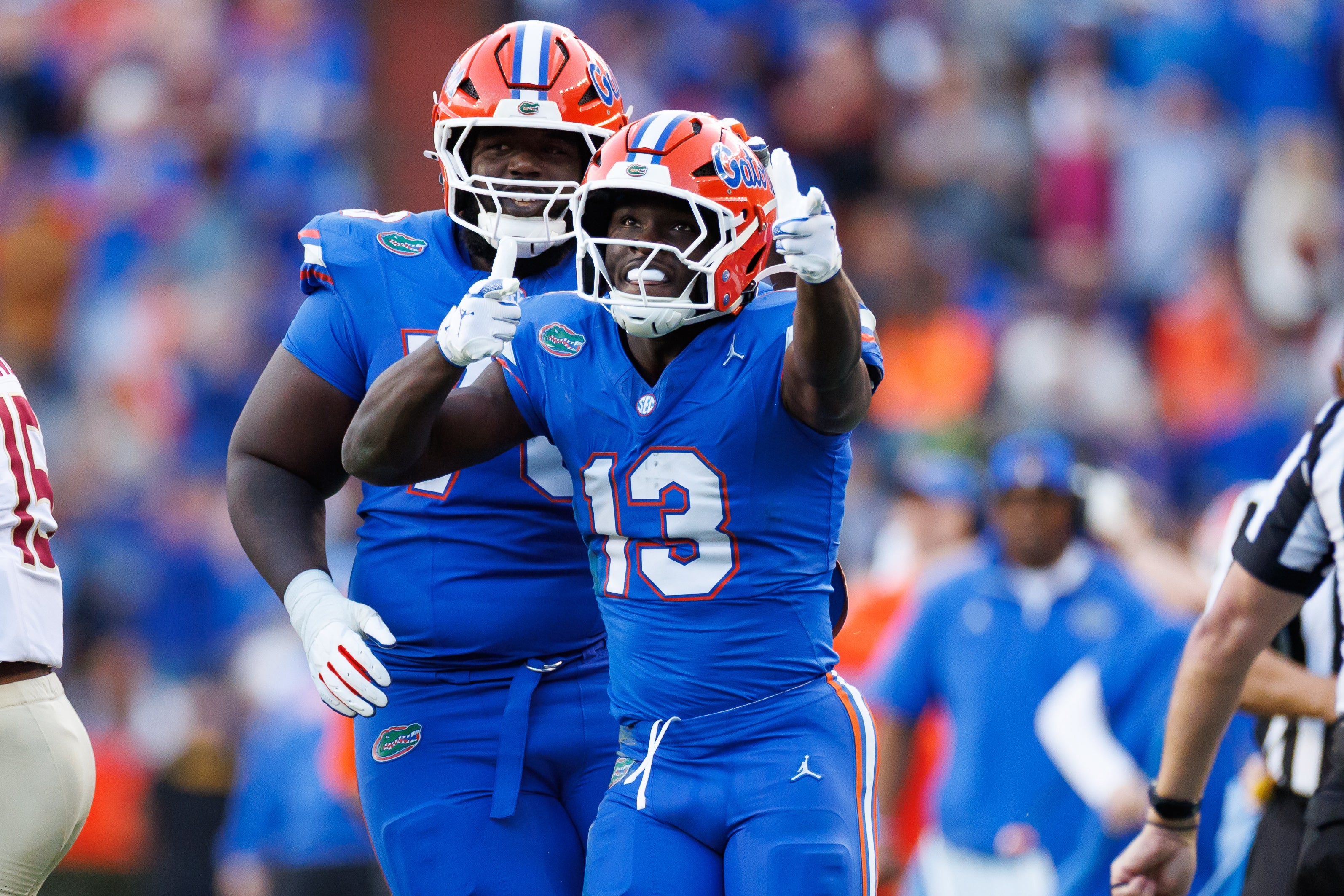 Nov 29, 2025; Gainesville, Florida, USA; Florida Gators running back Jadan Baugh (13) gestures with Florida Gators offensive lineman Daniel Pierre-Louis (73) against the Florida State Seminoles during the first half at Ben Hill Griffin Stadium.