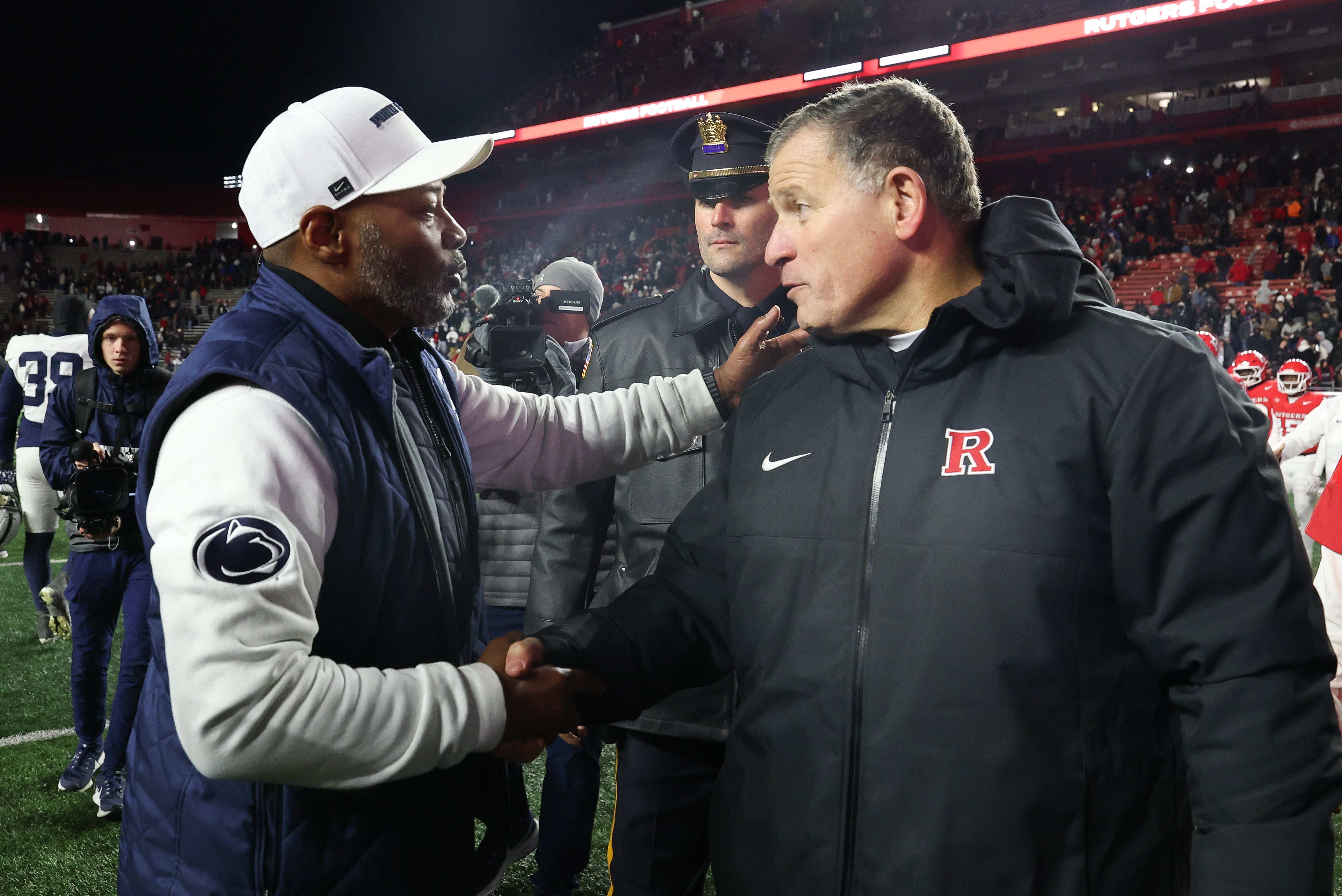 Nov 29, 2025; Piscataway, New Jersey, USA; Penn State Nittany Lions interim head coach Terry Smith and Rutgers Scarlet Knights head coach Greg Schiano shake hands after the game at SHI Stadium. Mandatory Credit: Vincent Carchietta-Imagn Images