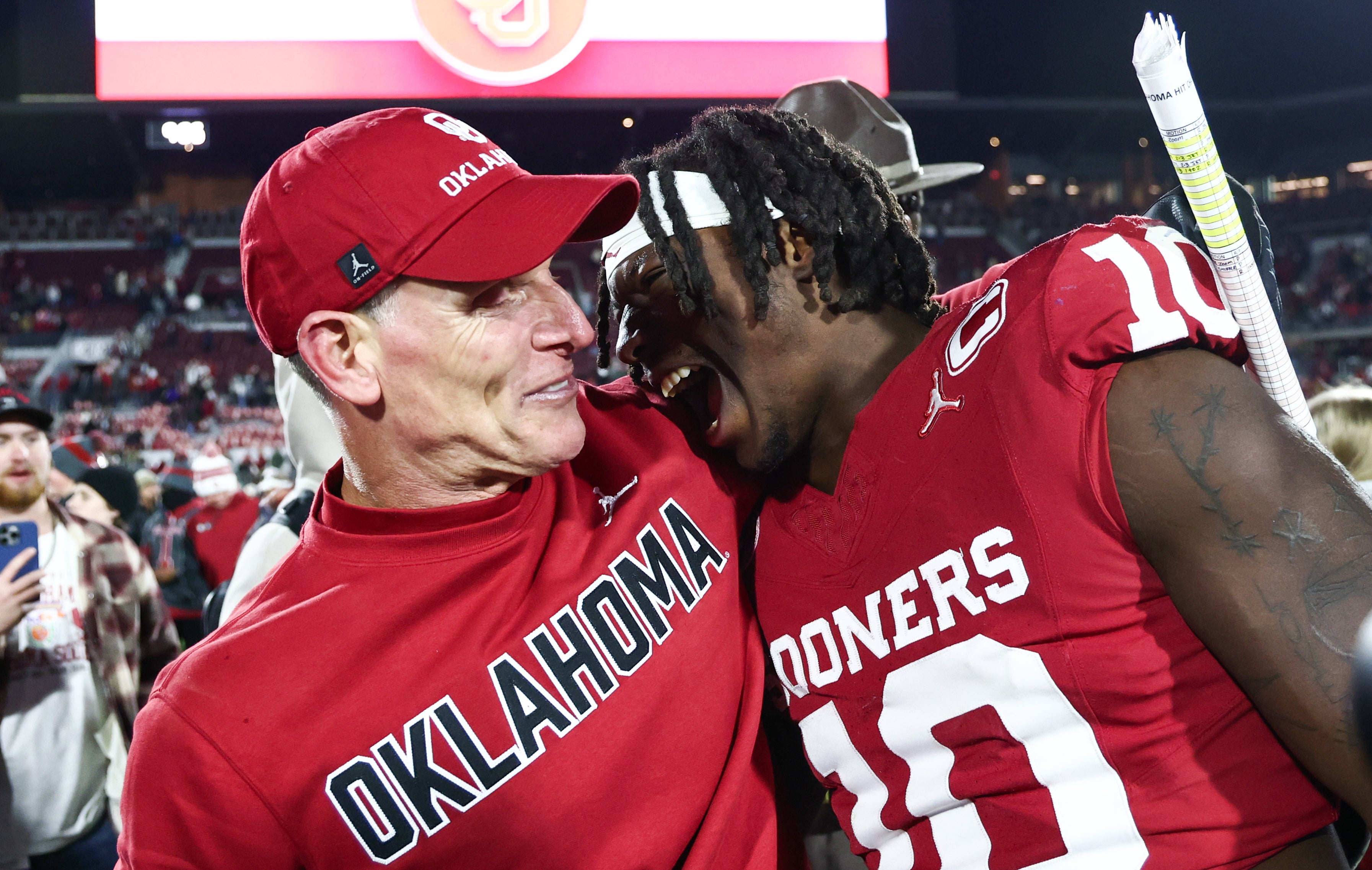 Oklahoma Sooners head coach Brent Venables linebacker Kip Lewis after win over LSU Tigers