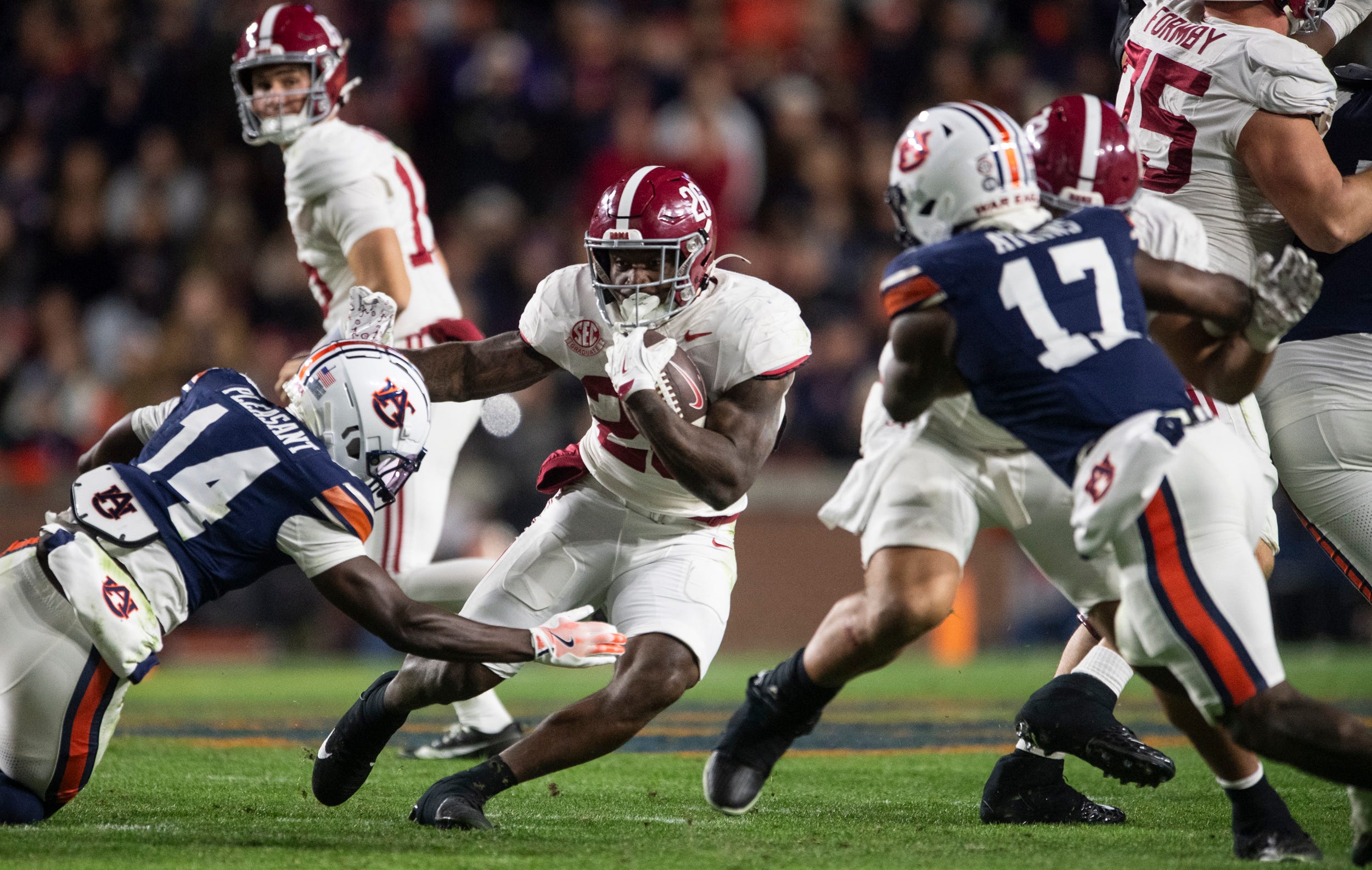 Alabama Crimson Tide running back Jam Miller (26) runs the ball as Auburn Tigers take on Alabama Crimson Tide in the Iron Bowl at Jordan-Hare Stadium in Auburn, Ala. on Saturday, Nov. 29, 2025. Alabama Crimson Tide leads Auburn Tigers 17-6.