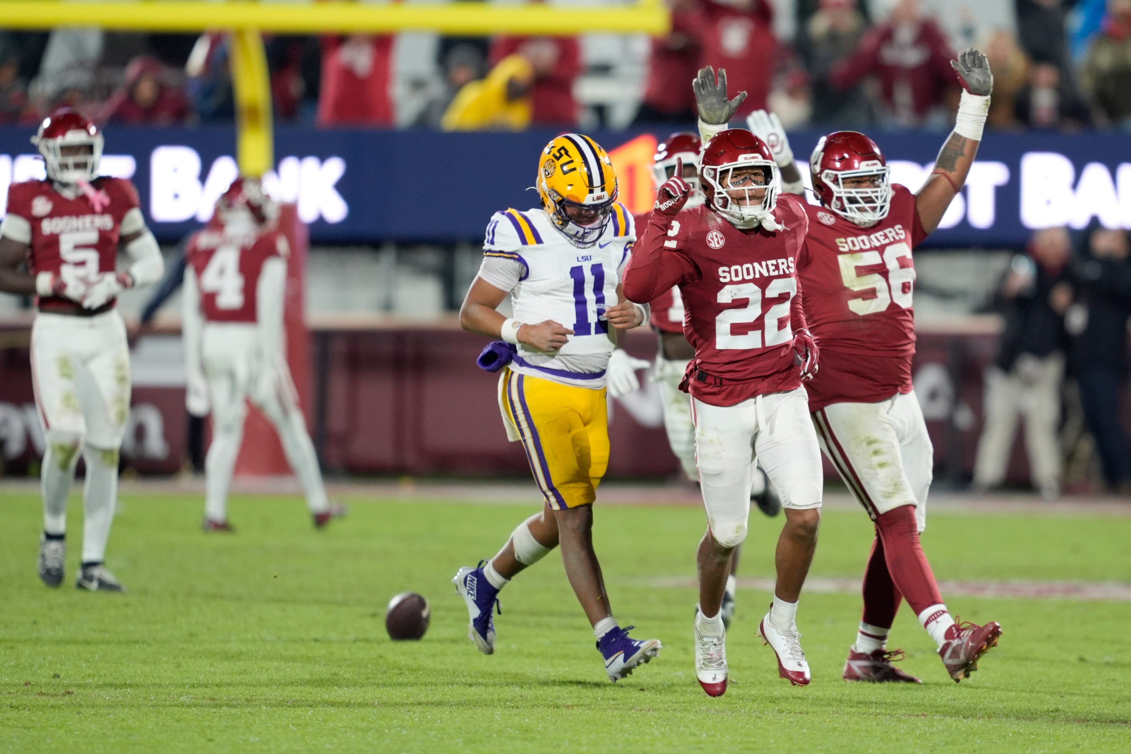 Oklahoma Sooners defensive back Peyton Bowen (22) and Oklahoma Sooners defensive lineman Gracen Halton (56) celebrate beside Louisiana State Tigers quarterback Michael Van Buren Jr. (11) after stopping LSU on thier final possession of a college football game between the University of Oklahoma Sooners (OU) and the LSU Tigers at Gaylord Family - Oklahoma Memorial Stadium in Norman, Okla., Saturday, Nov. 29, 2025. Oklahoma won 17-13.