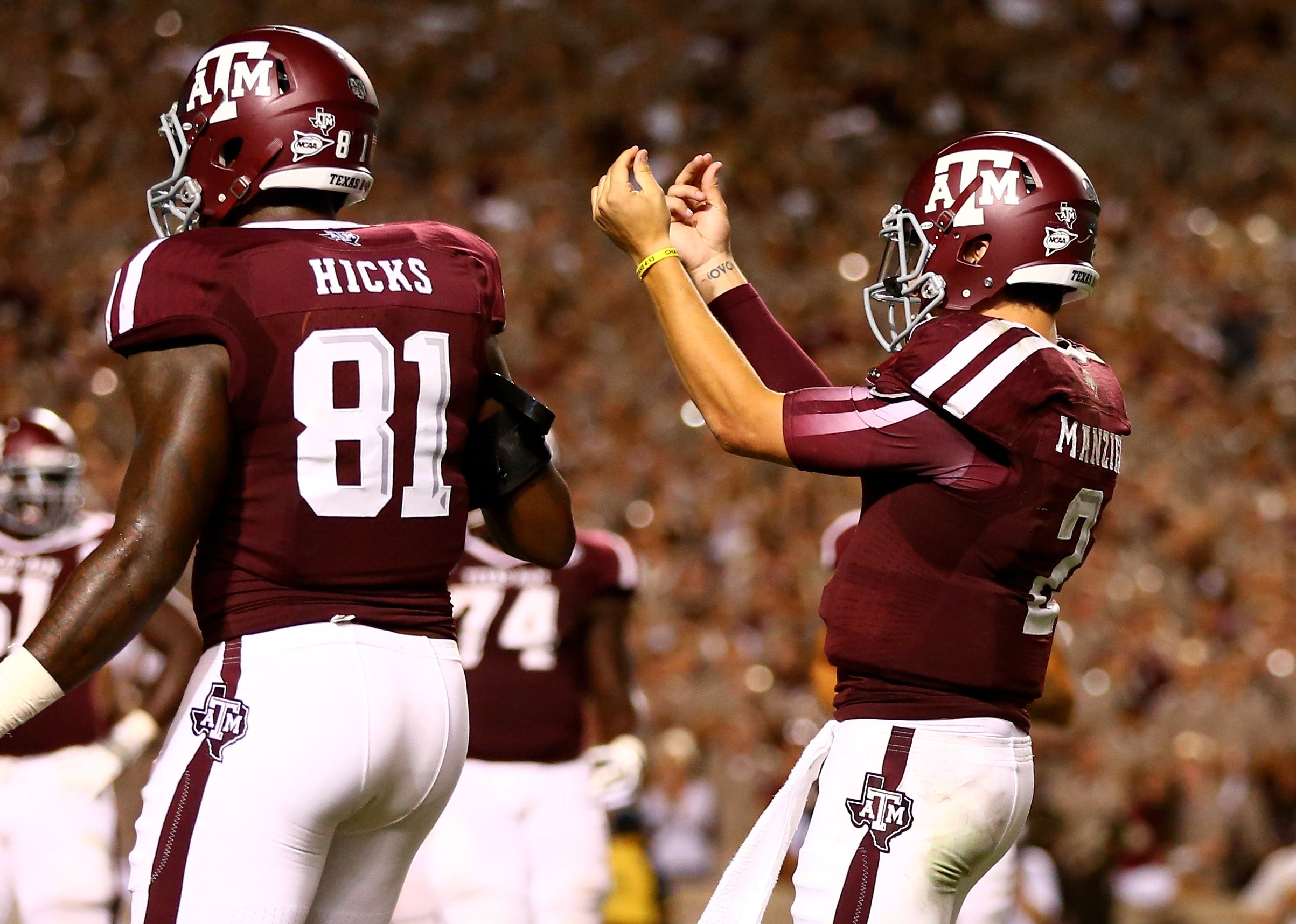 Sep 21, 2013; College Station, TX, USA; Texas A&M Aggies quarterback Johnny Manziel (2) gestures with his fingers as he celebrates a third quarter touchdown against the SMU Mustangs at Kyle Field. M