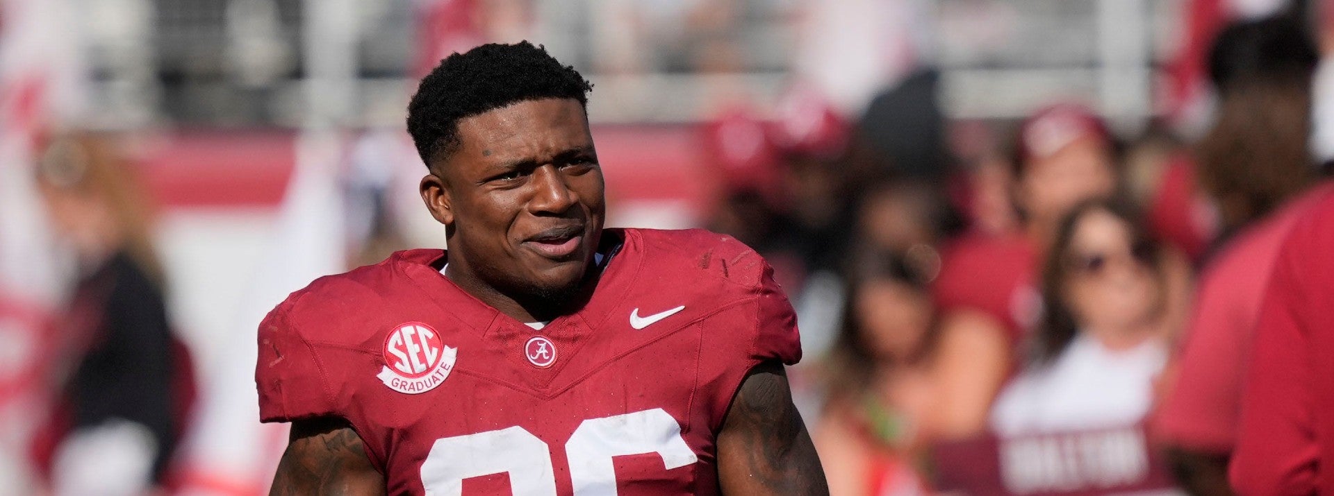 Nov 22, 2025; Tuscaloosa, Alabama, USA; Alabama running back Jam Miller (26) walks to his family with a rose in hand on Senior Day at Saban Field at Bryant-Denny Stadium.