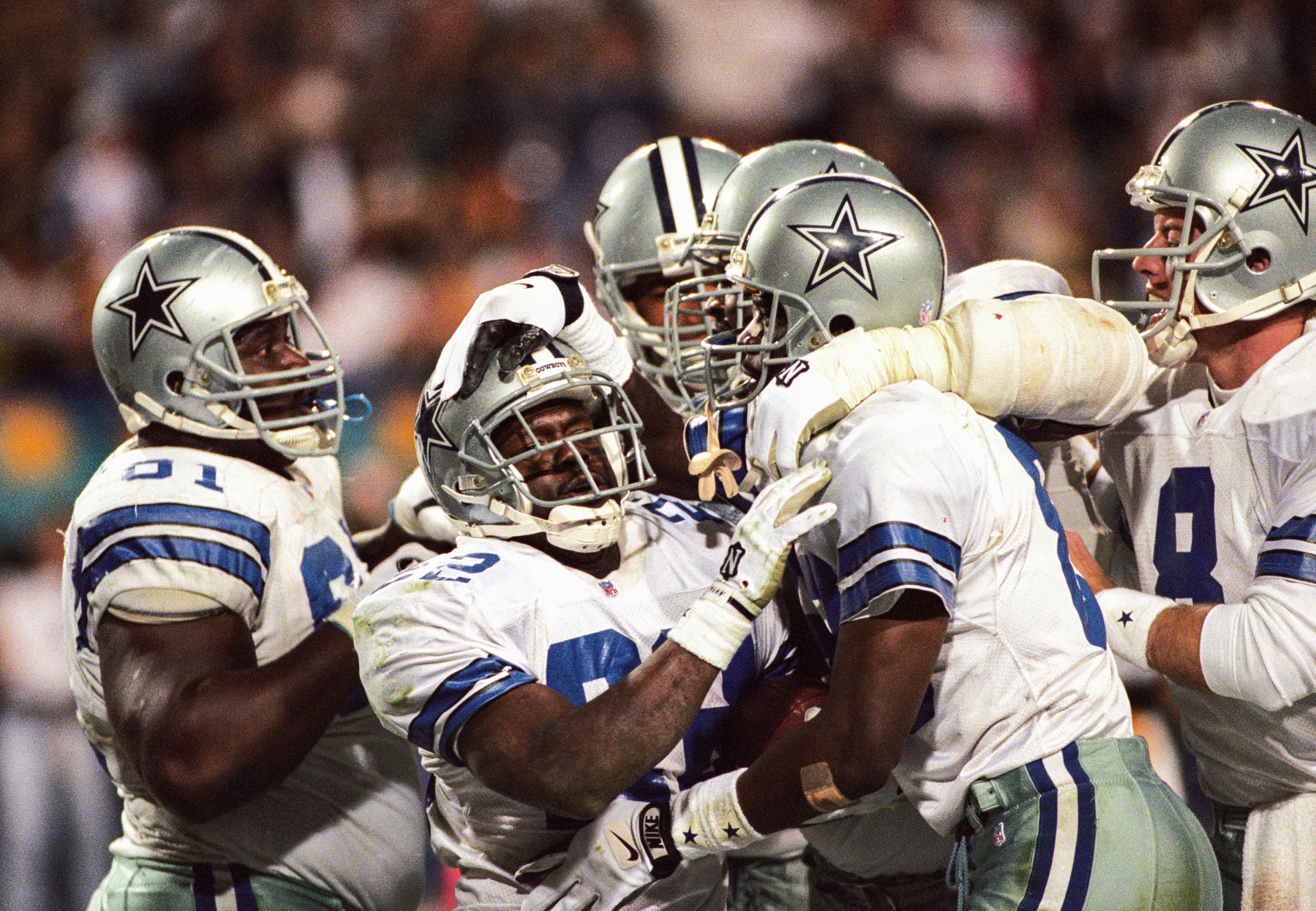 Jan 28, 1996; Tempe, AZ, USA; FILE PHOTO; Dallas Cowboys running back Emmitt Smith (22), guard Nate Newton (61), receiver Michael Irvin (88) and quarterback Troy Aikman (8) reacts after a touchdown against the Pittsburgh Steelers during Super Bowl XXX at Sun Devil Stadium. The Cowboys defeated the Steelers 27-17.