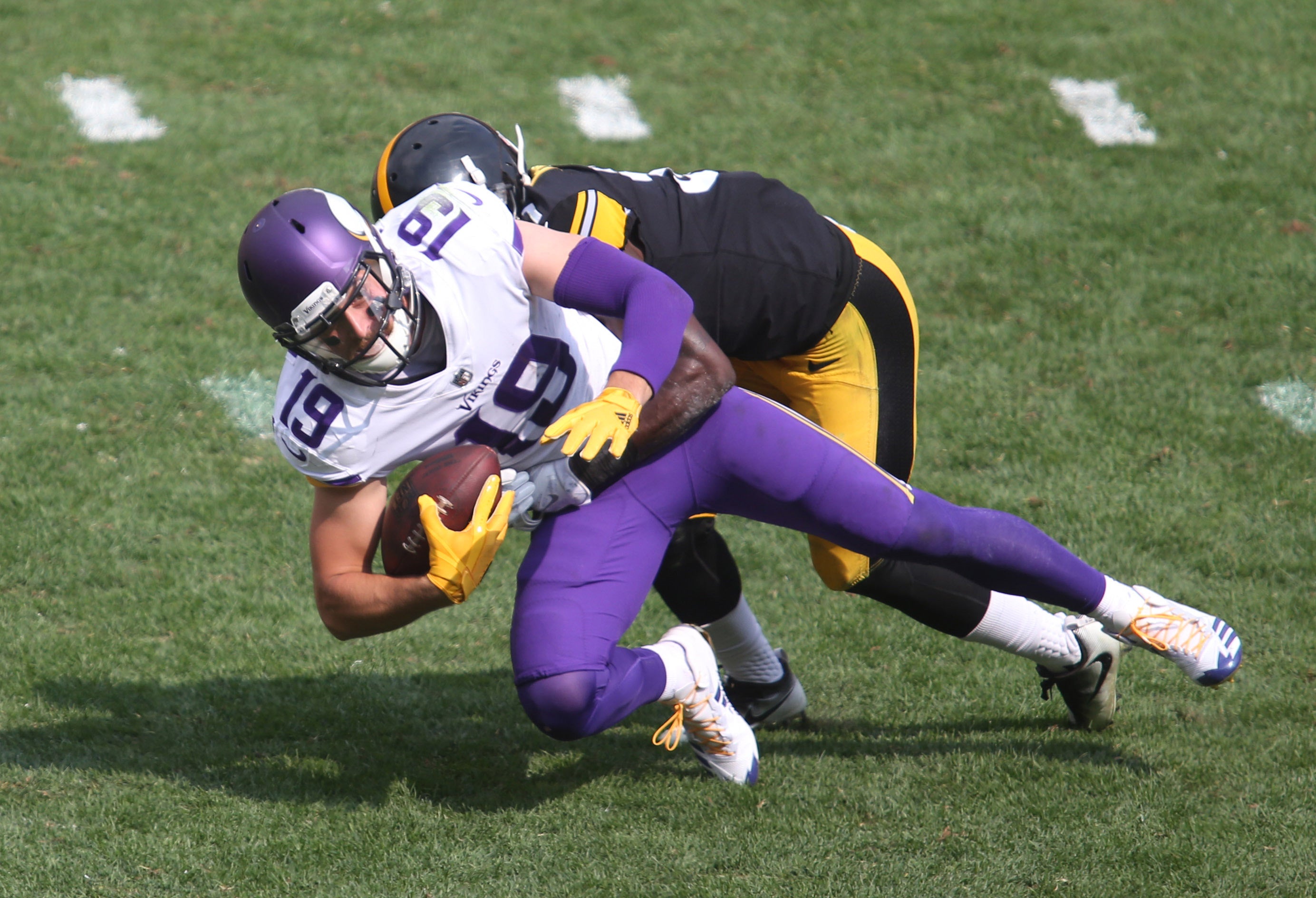 Sep 17, 2017; Pittsburgh, PA, USA; Minnesota Vikings wide receiver Adam Thielen (19) is tackled after a catch by Pittsburgh Steelers cornerback Mike Hilton (rear) during the third quarter at Heinz Field. The Steelers won 26-9.