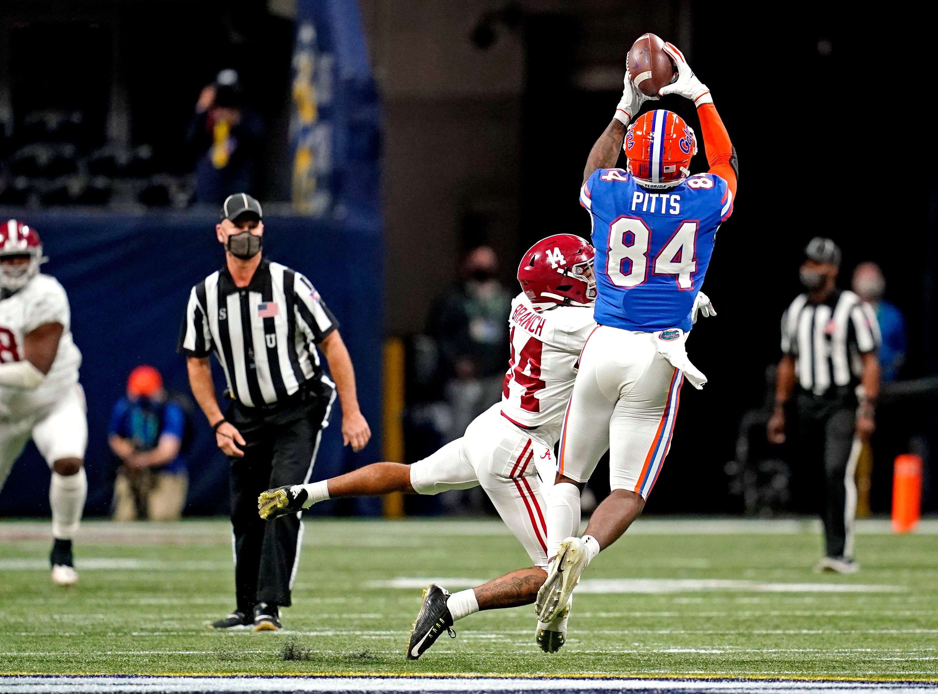 Dec 19, 2020; Atlanta, Georgia, USA; Florida Gators tight end Kyle Pitts (84) catches the ball against Alabama Crimson Tide defensive back Brian Branch (14) during the first quarter in the SEC Championship at Mercedes-Benz Stadium.