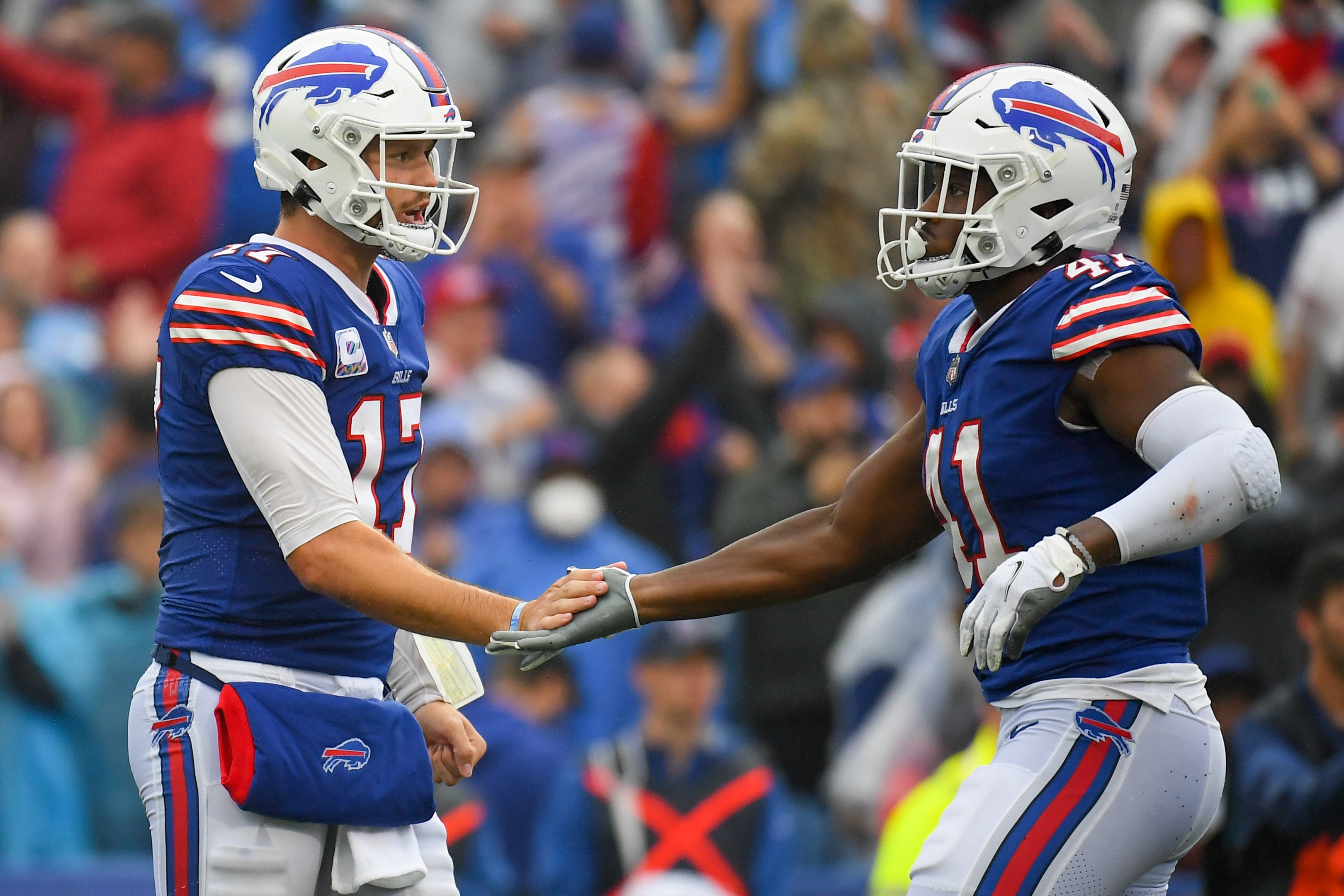 Oct 3, 2021; Orchard Park, New York, USA; Buffalo Bills quarterback Josh Allen (17) celebrates a play with teammate fullback Reggie Gilliam (41) against the Houston Texans during the second half at Highmark Stadium.