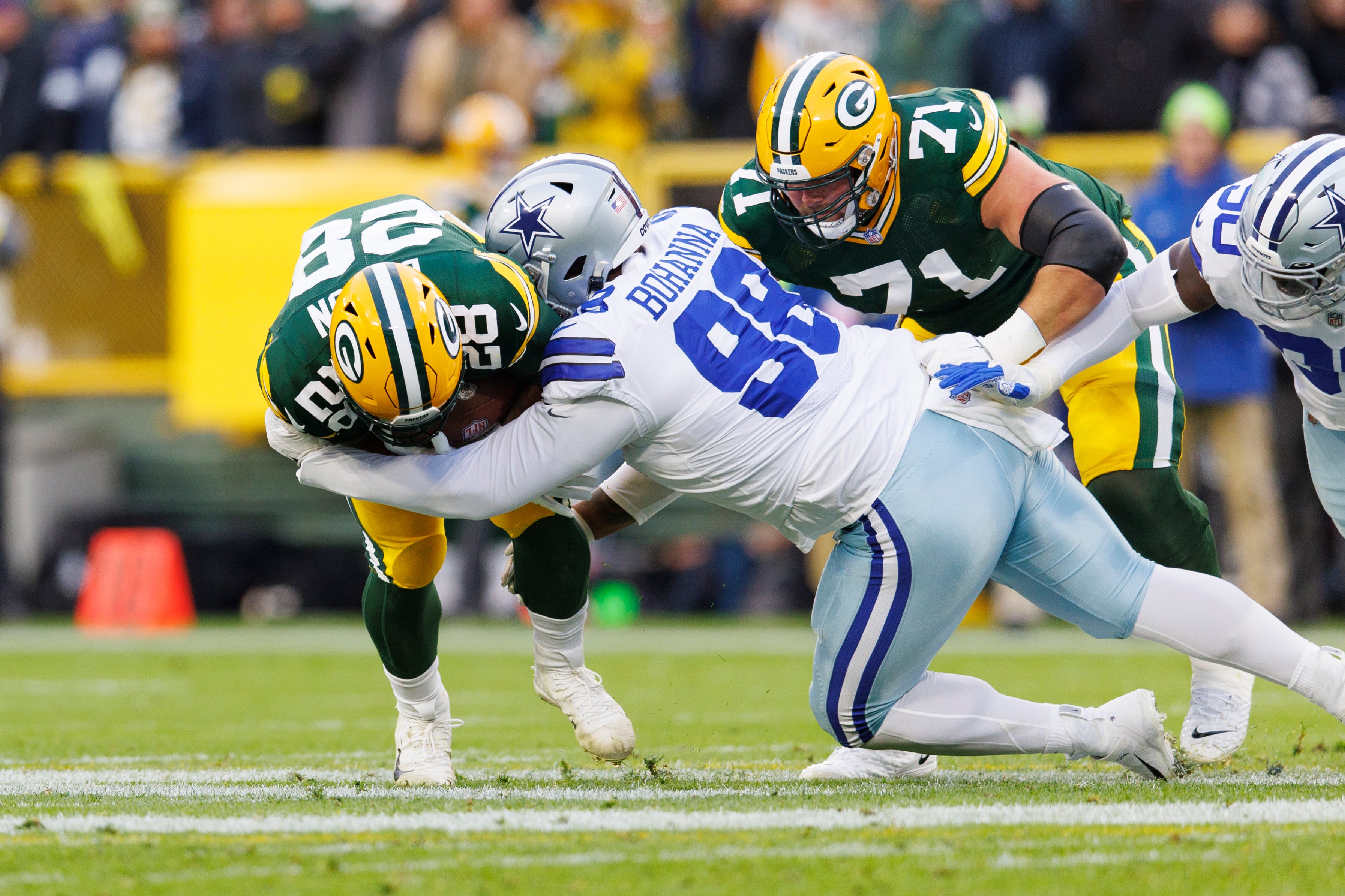 Nov 13, 2022; Green Bay, Wisconsin, USA; Dallas Cowboys defensive tackle Quinton Bohanna (98) tackles Green Bay Packers running back AJ Dillon (28) during the first quarter at Lambeau Field.