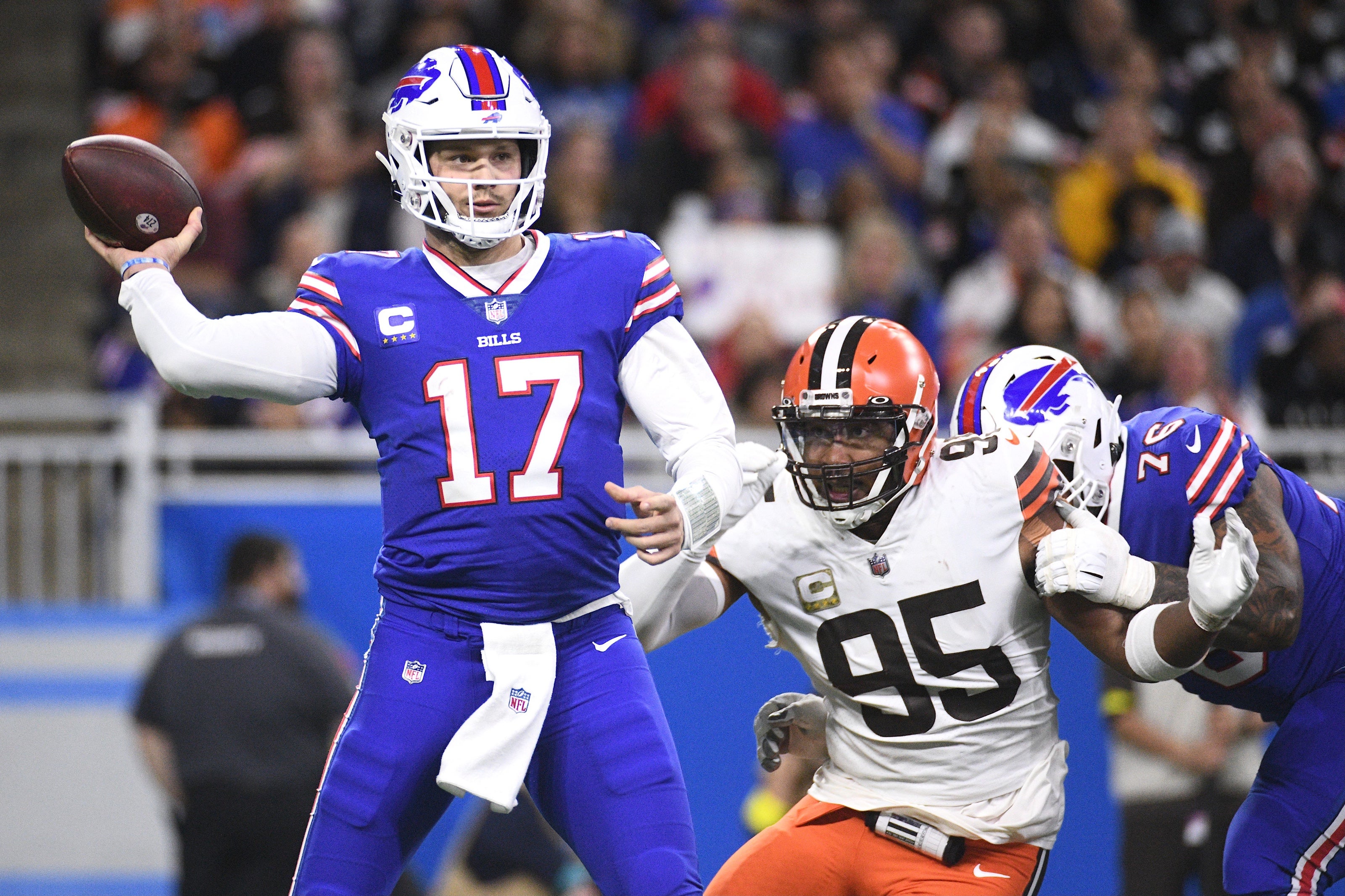Nov 20, 2022; Detroit, Michigan, USA; Buffalo Bills quarterback Josh Allen (17) drops back to throw the ball as guard Rodger Saffold (76) blocks Cleveland Browns defensive end Myles Garrett (95) during the first half at Ford Field.