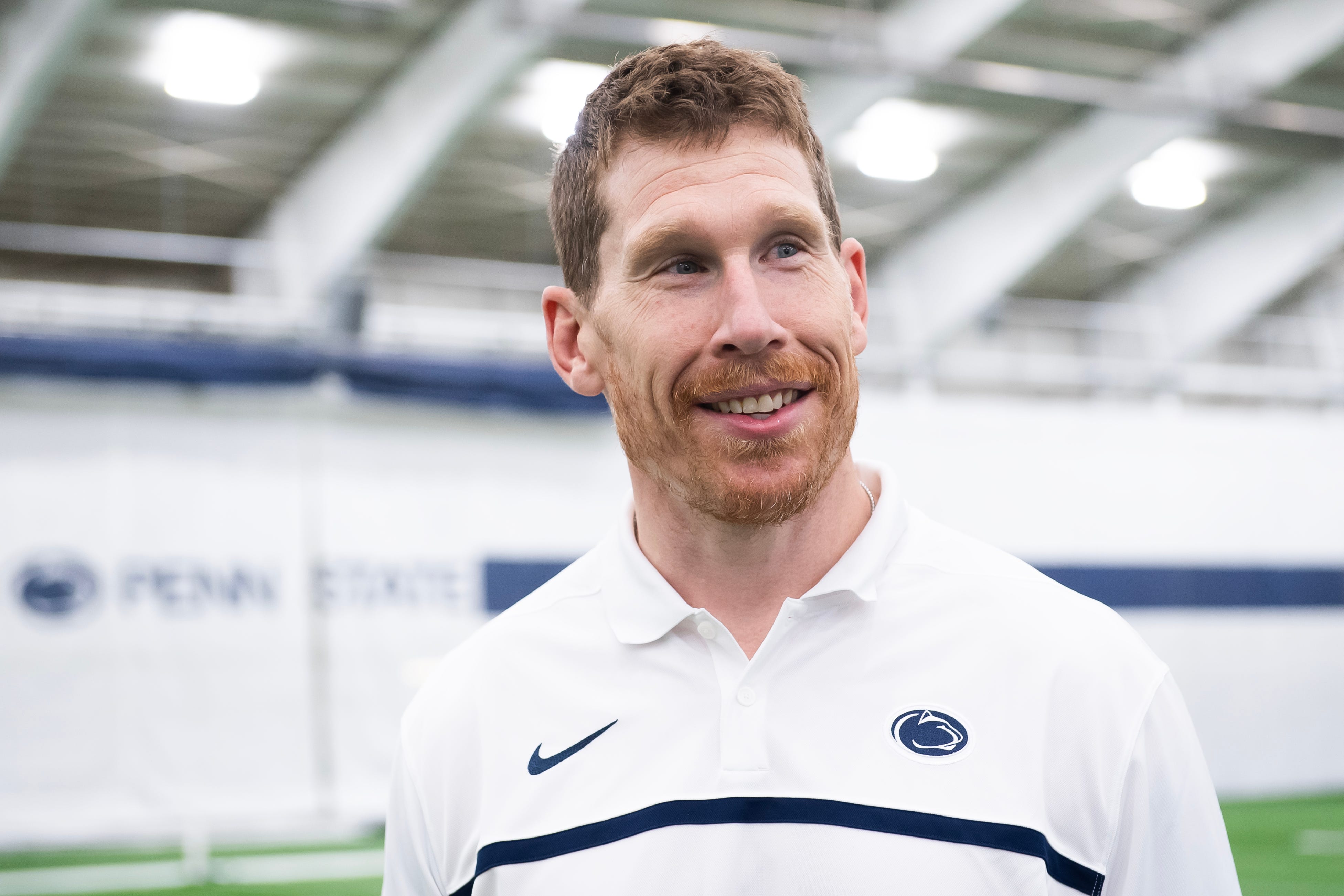 Penn State football offensive line coach Phil Trautwein smiles as he listens to a question from a reporter during an interview in Holuba Hall on Thursday, June 13, 2024, in State College.