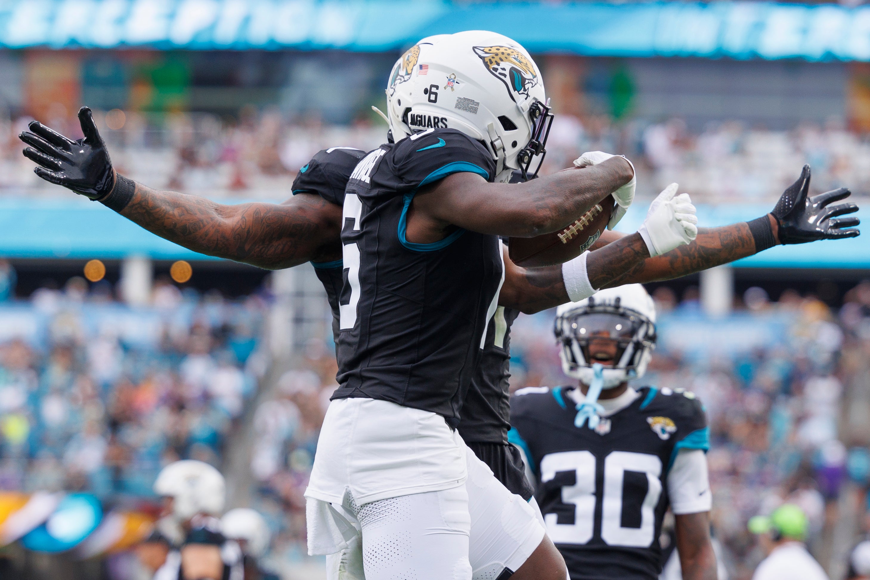 Nov 10, 2024; Jacksonville, Florida, USA; Jacksonville Jaguars safety Darnell Savage (6) celebrates an interception with safety Antonio Johnson (26) against the Minnesota Vikings during the third quarter at EverBank Stadium.