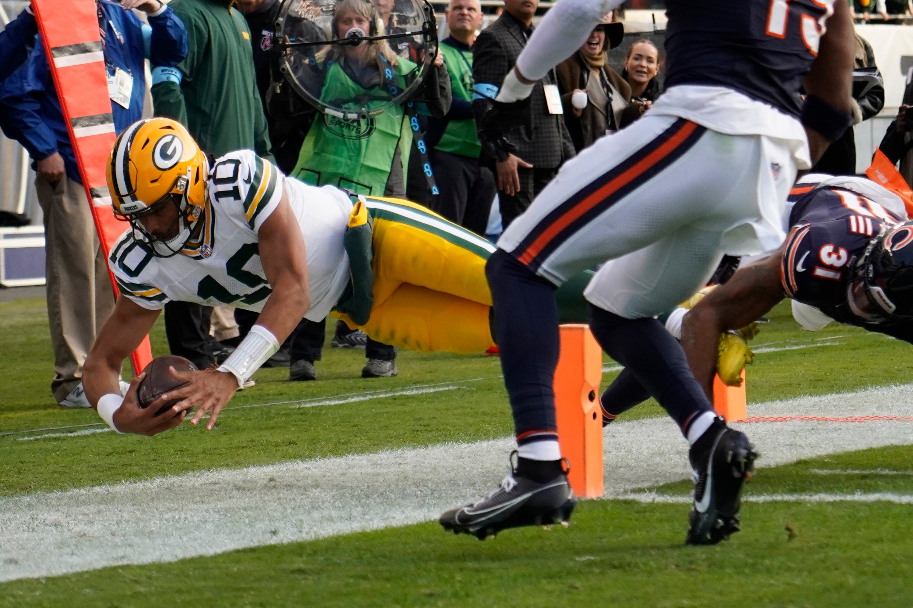 Nov 17, 2024; Chicago, Illinois, USA; Green Bay Packers quarterback Jordan Love (10) dives into the end zone against Chicago Bears safety Kevin Byard III (31) during the second half at Soldier Field.