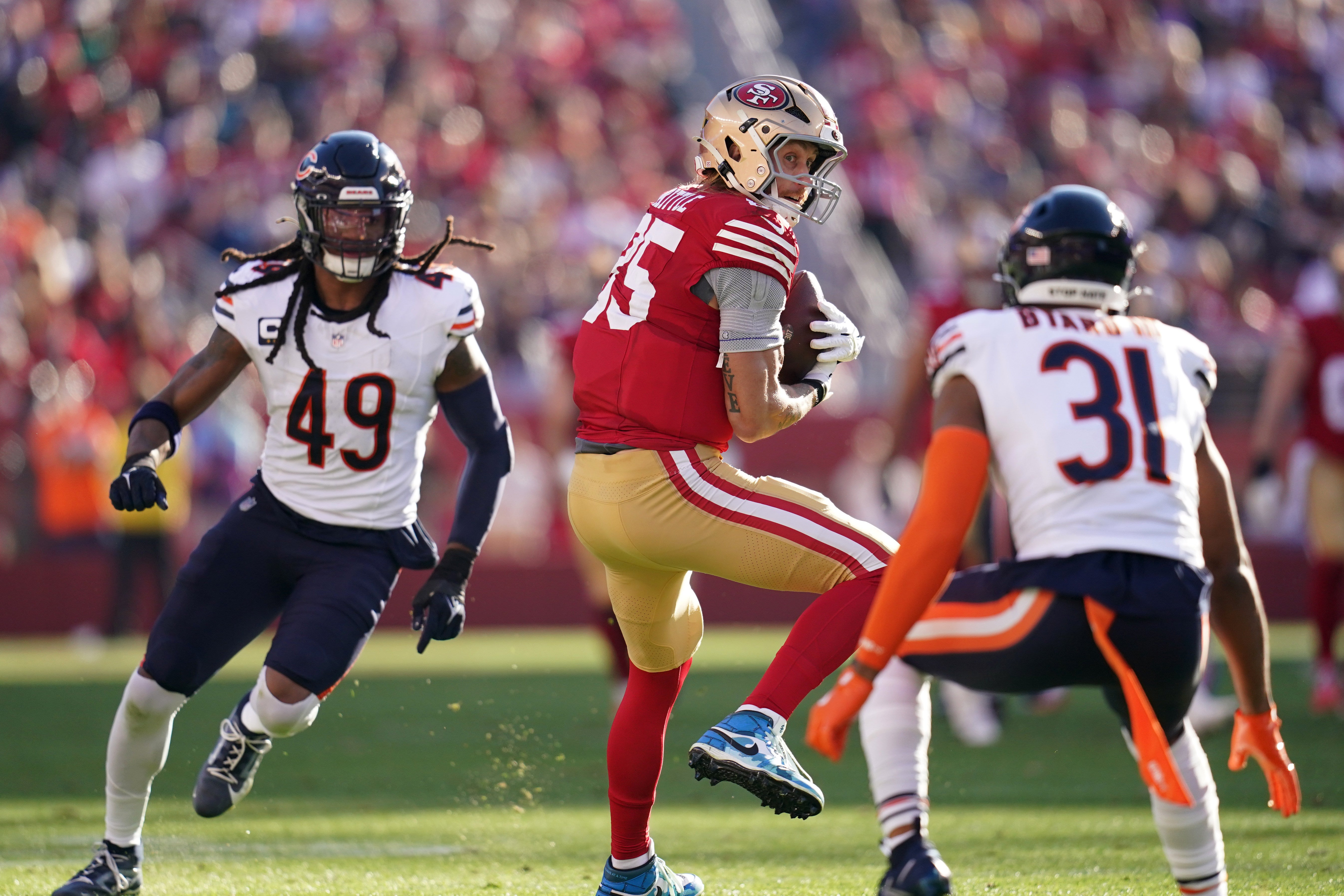 Dec 8, 2024; Santa Clara, California, USA; San Francisco 49ers tight end George Kittle (85) catches a pass between Chicago Bears linebacker Tremaine Edmunds (49) and safety Kevin Byard III (31) in the first quarter at Levi's Stadium.