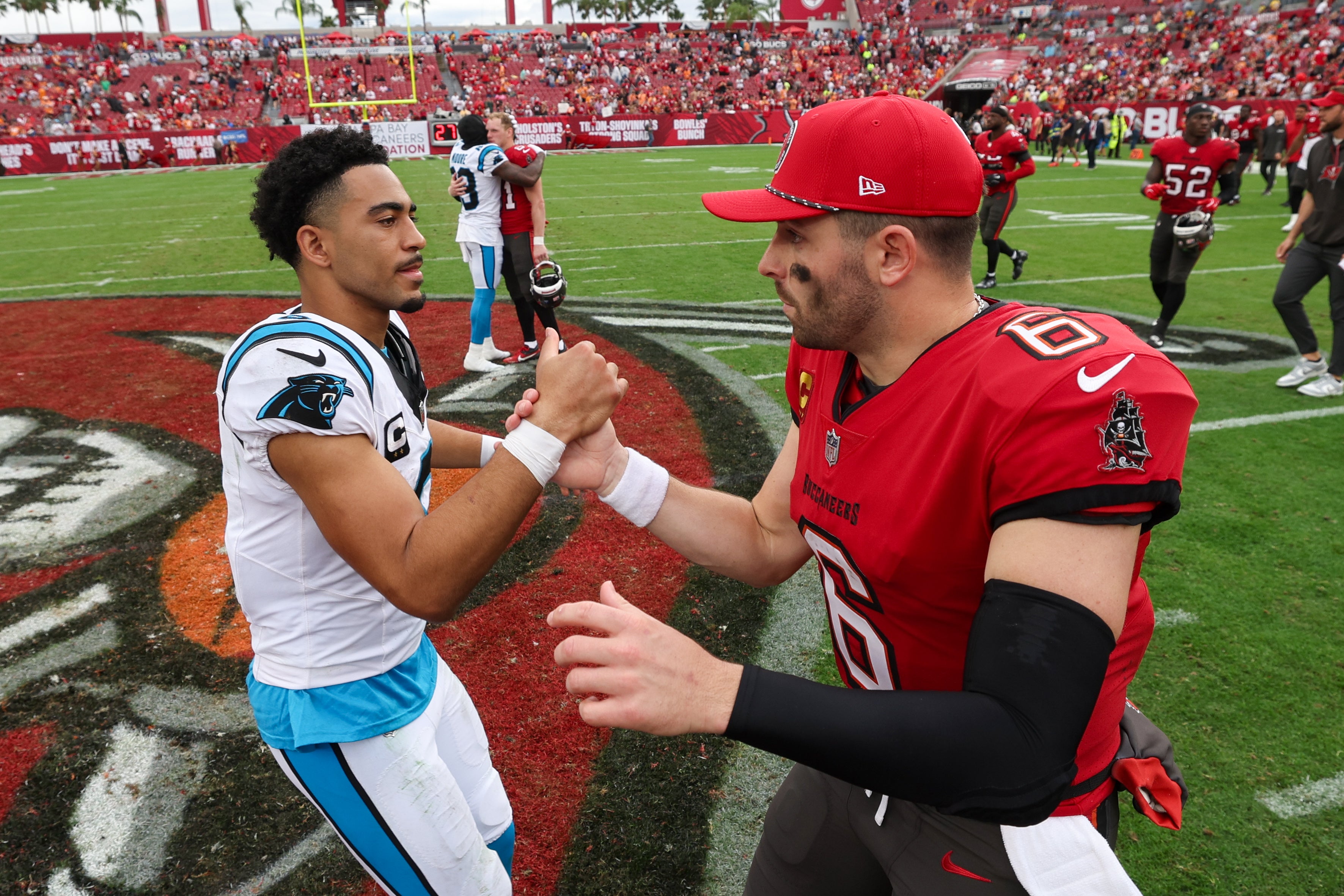 Dec 29, 2024; Tampa, Florida, USA; Tampa Bay Buccaneers quarterback Baker Mayfield (6) great Carolina Panthers quarterback Bryce Young (9) after a game at Raymond James Stadium.