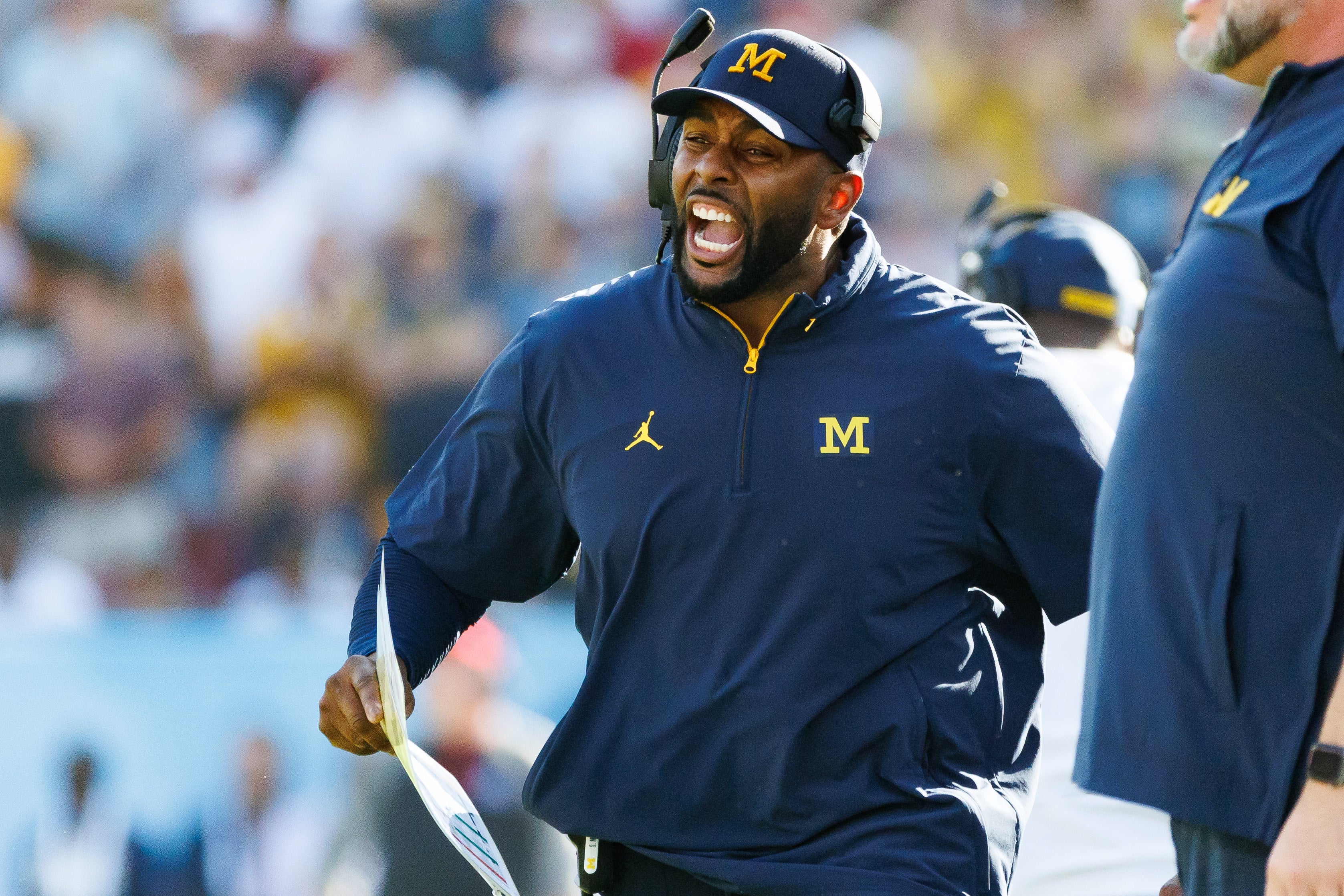 Dec 31, 2024; Tampa, FL, USA; Michigan Wolverines head coach Sherrone Moore screams from the sideline against the Alabama Crimson Tide during the second half at Raymond James Stadium. Mandatory Credit: Matt Pendleton-Imagn Images