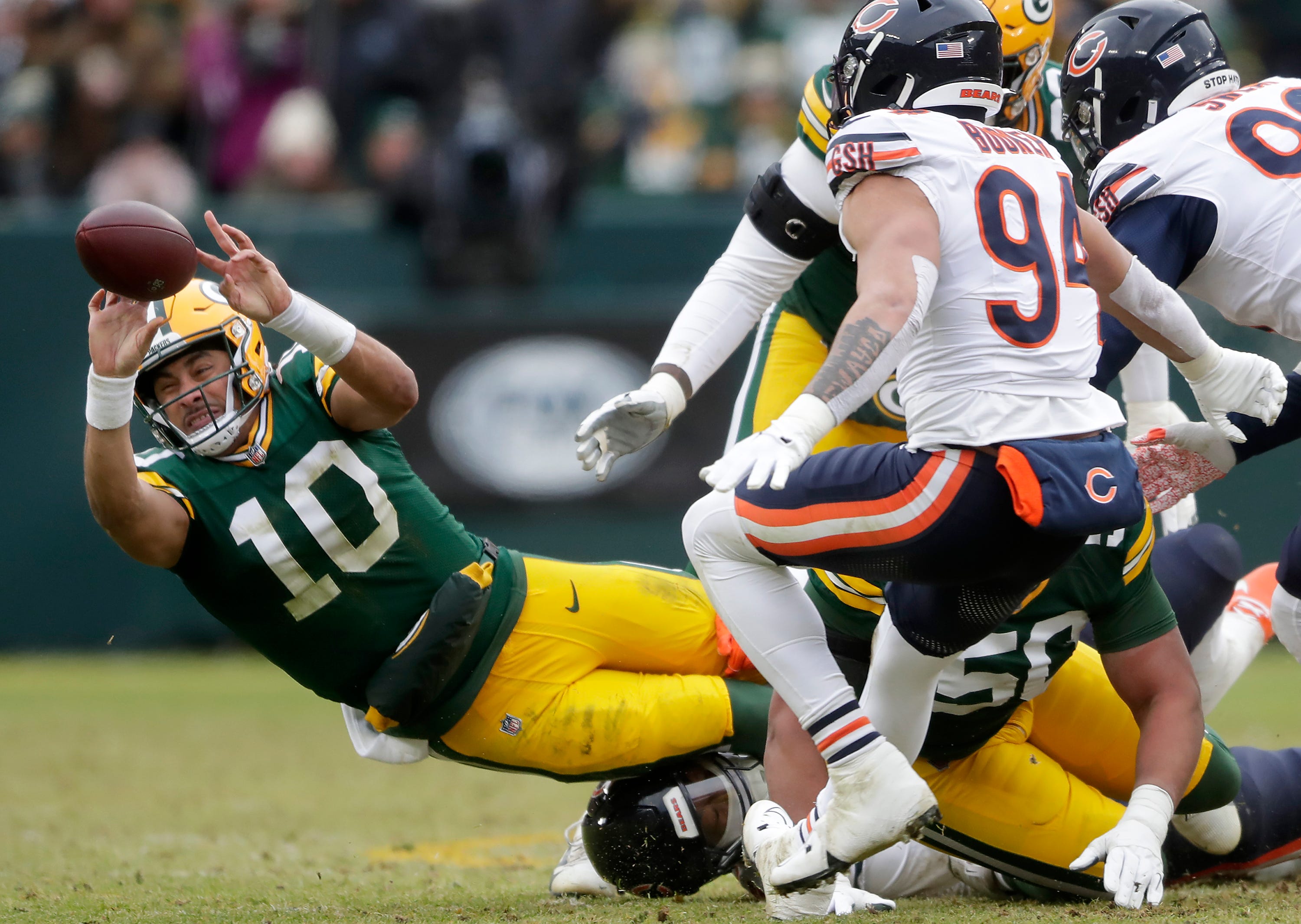 Green Bay Packers quarterback Jordan Love (10) is tackled by Chicago Bears defensive tackle Gervon Dexter Sr. (99) against the Chicago Bears on Sunday, January 5, 2024 at Lambeau Field in Green Bay, Wis.