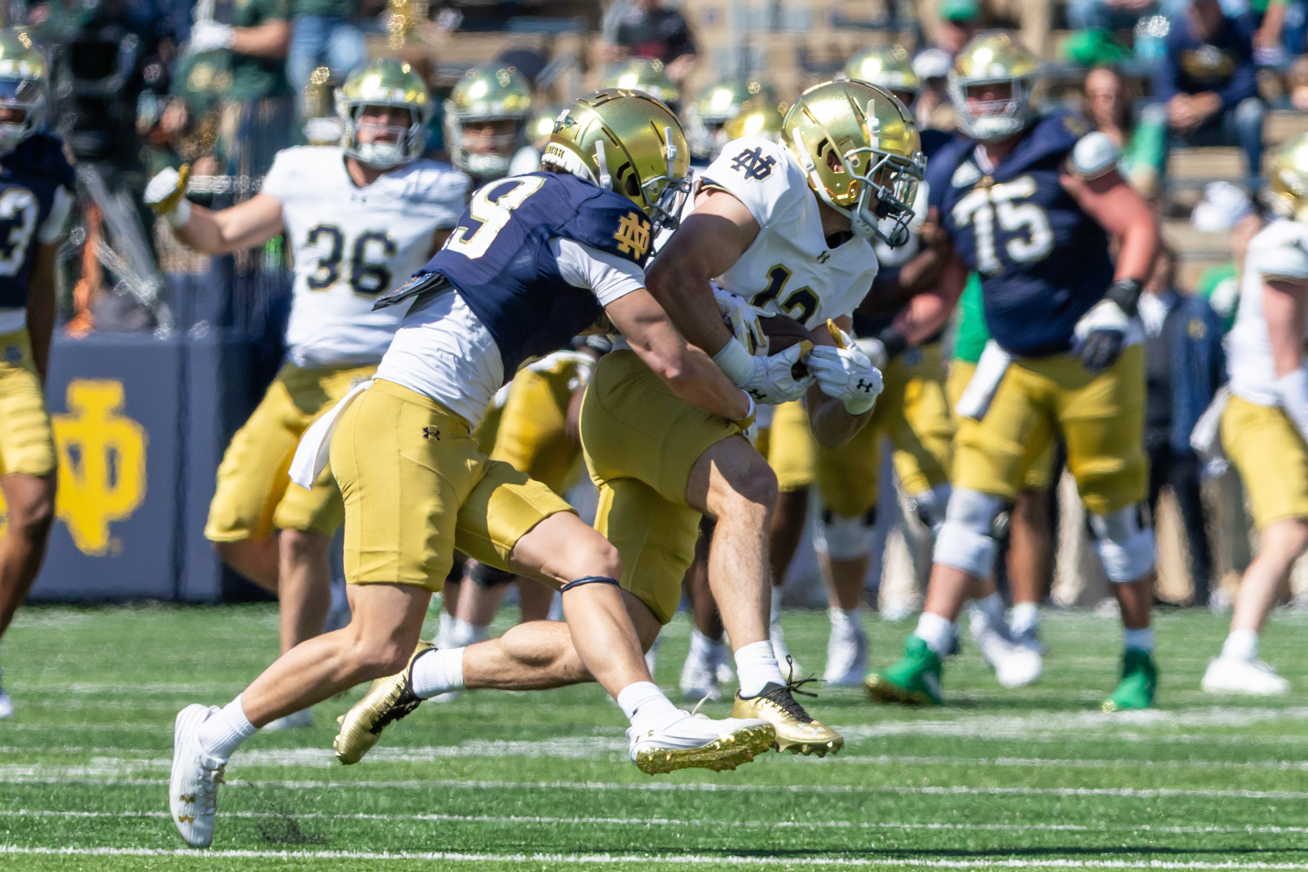 Apr 12, 2025; Notre Dame, IN, USA; Notre Dame Fighting Irish safety Ben Minich (right) intercepts a pass intended for Notre Dame Fighting Irish wide receiver Logan Saldate (left) during the Blue-Gold game at Notre Dame Stadium. Mandatory Credit: Michael Caterina-Imagn Images