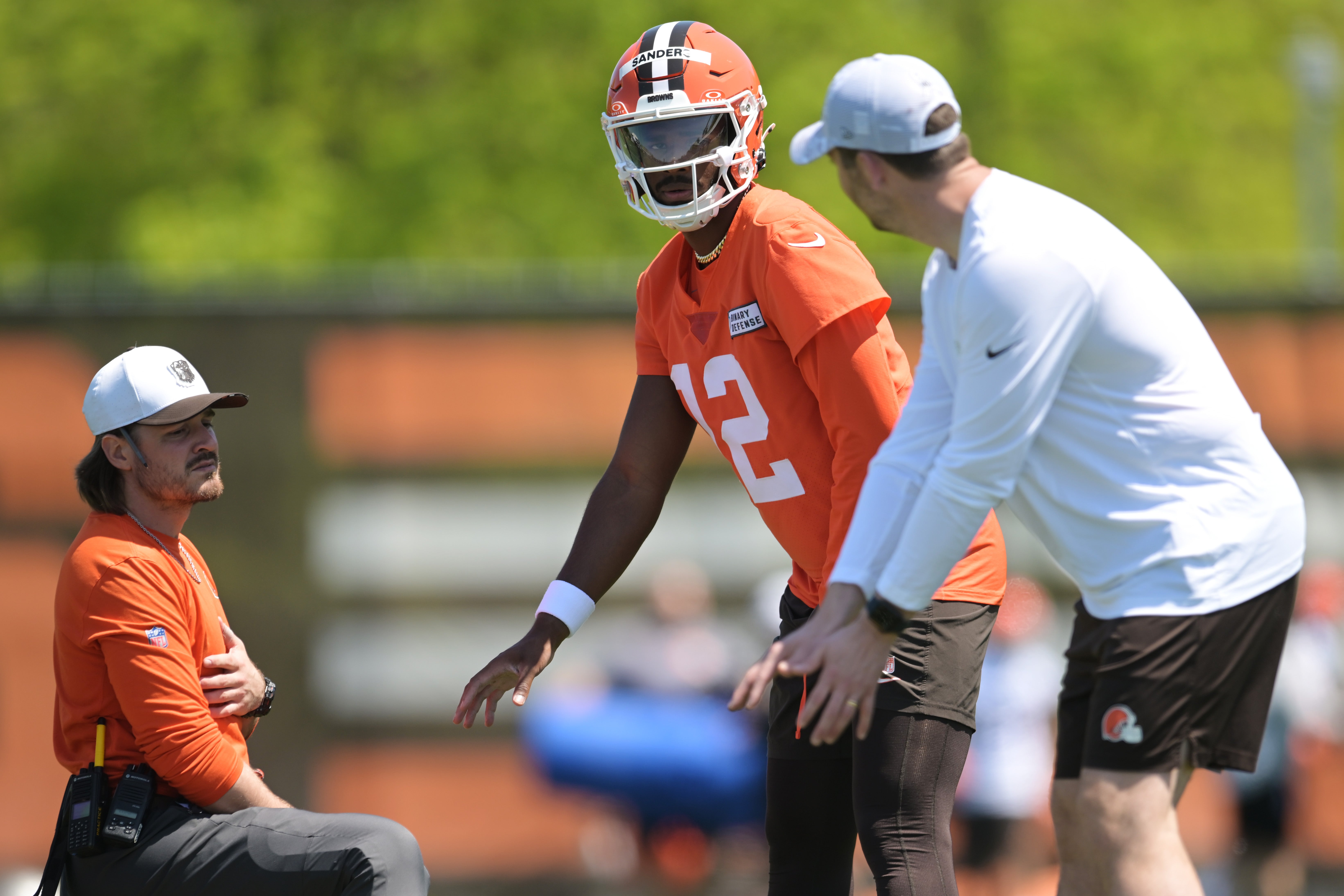 May 10, 2025; Berea, OH, USA; Cleveland Browns quarterback Shedeur Sanders (12) listens to offensive coordinator Tommy Rees during rookie minicamp at CrossCountry Mortgage Campus. Mandatory Credit: Ken Blaze-Imagn Images