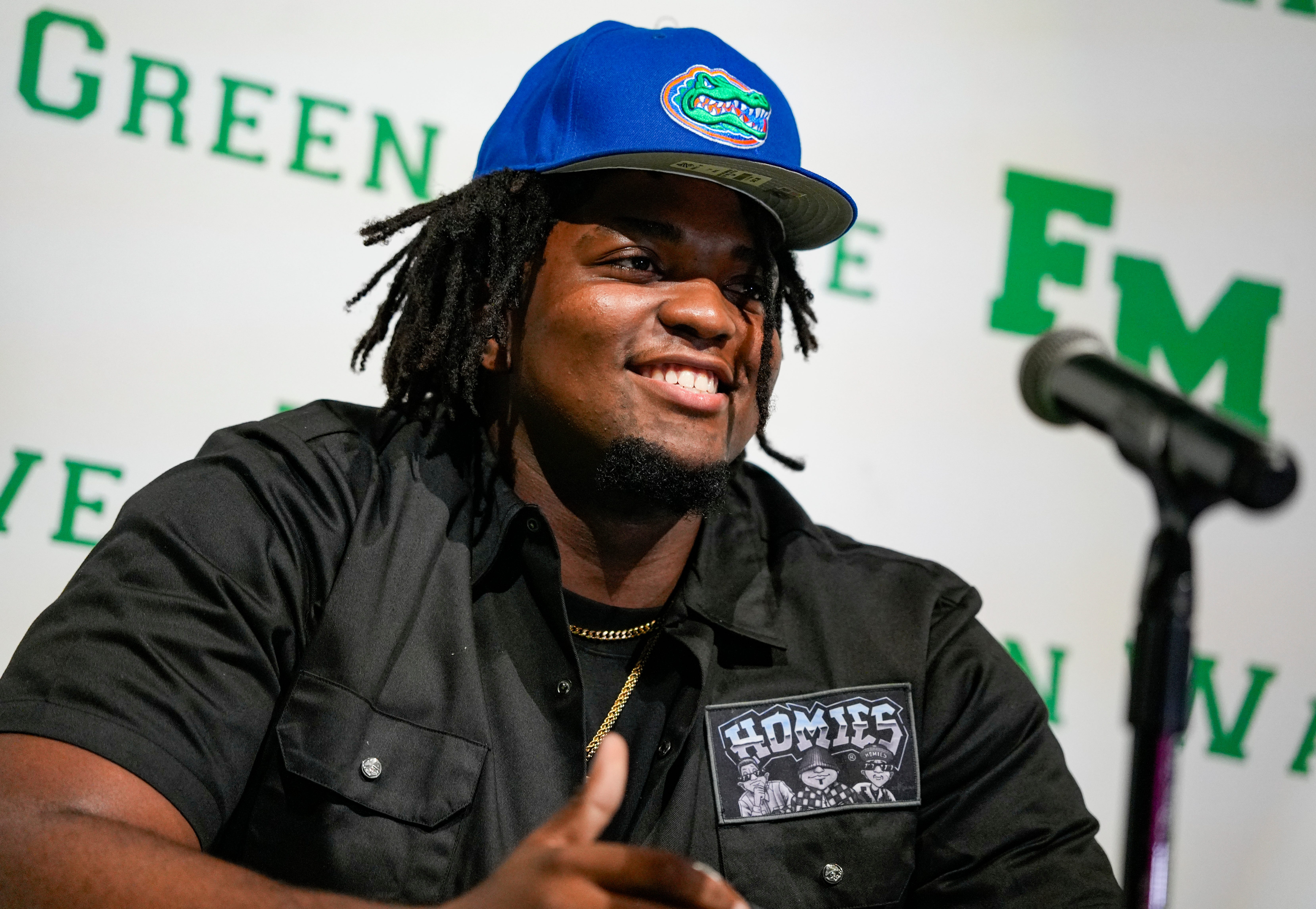 Fort Myers Green Wave defensive lineman Kendall Guervil commits to the University of Florida while surrounded by friends and family during a ceremony at Fort Myers High School in Fort Myers, Fla., on Wednesday, July 2, 2025.