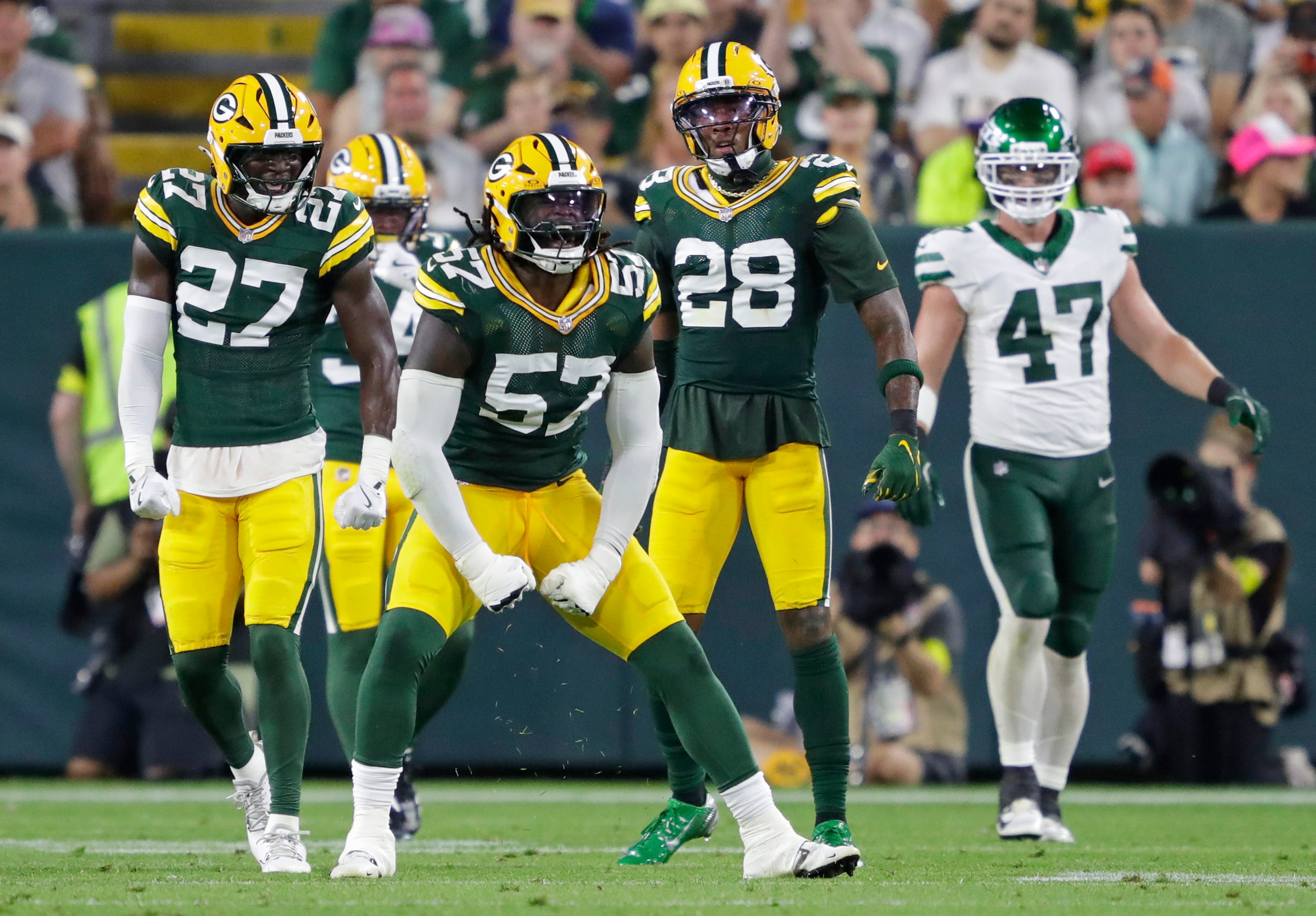 Aug 9, 2025; Green Bay, Wisconsin, USA; Green Bay Packers defensive end Brenton Cox Jr. (57) celebrates sacking New York Jets quarterback Brady Cook (4) during the second half at Lambeau Field.