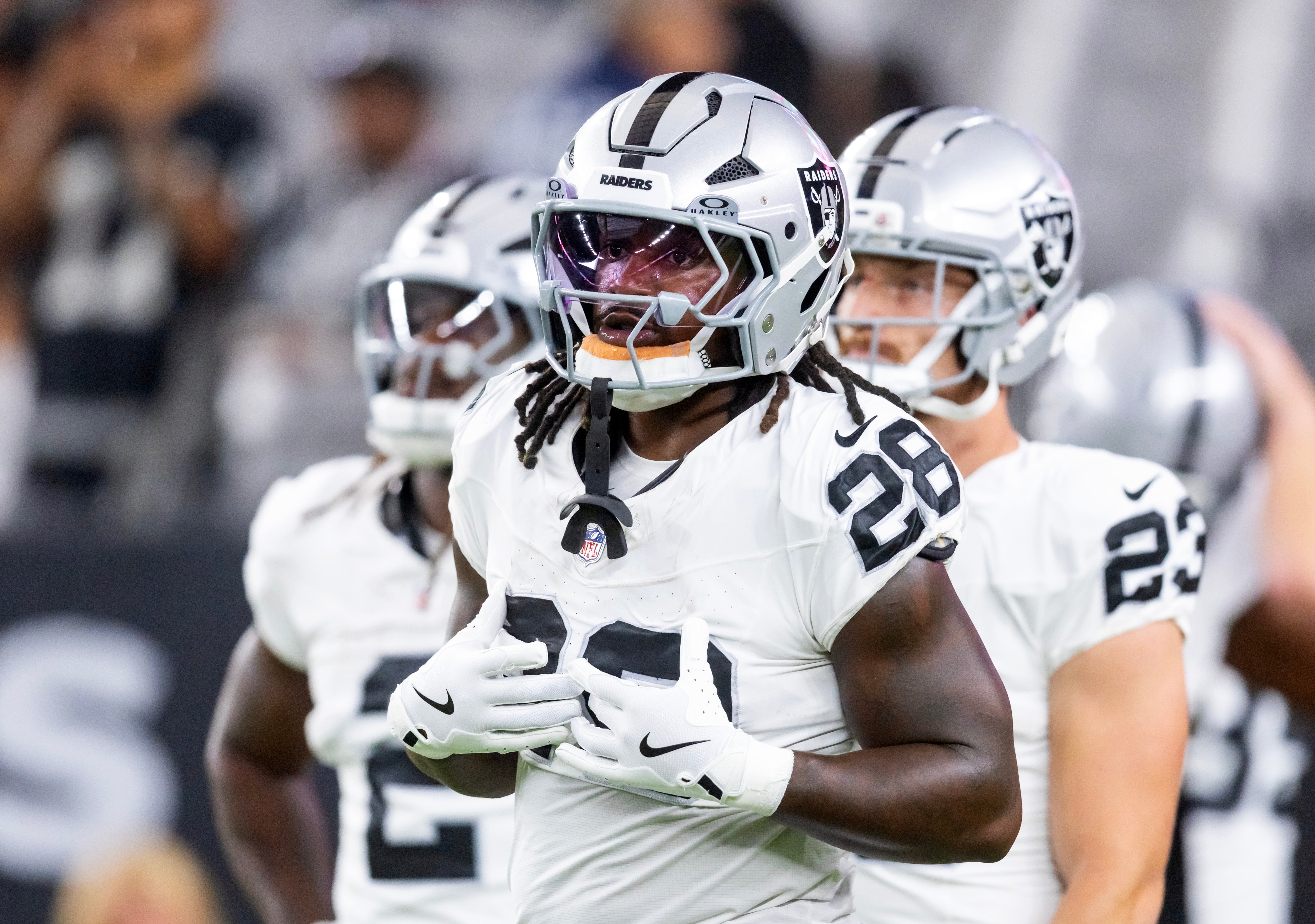 Aug 23, 2025; Glendale, Arizona, USA; Las Vegas Raiders running back Sincere McCormick (28) against the Arizona Cardinals during a preseason NFL game at State Farm Stadium.