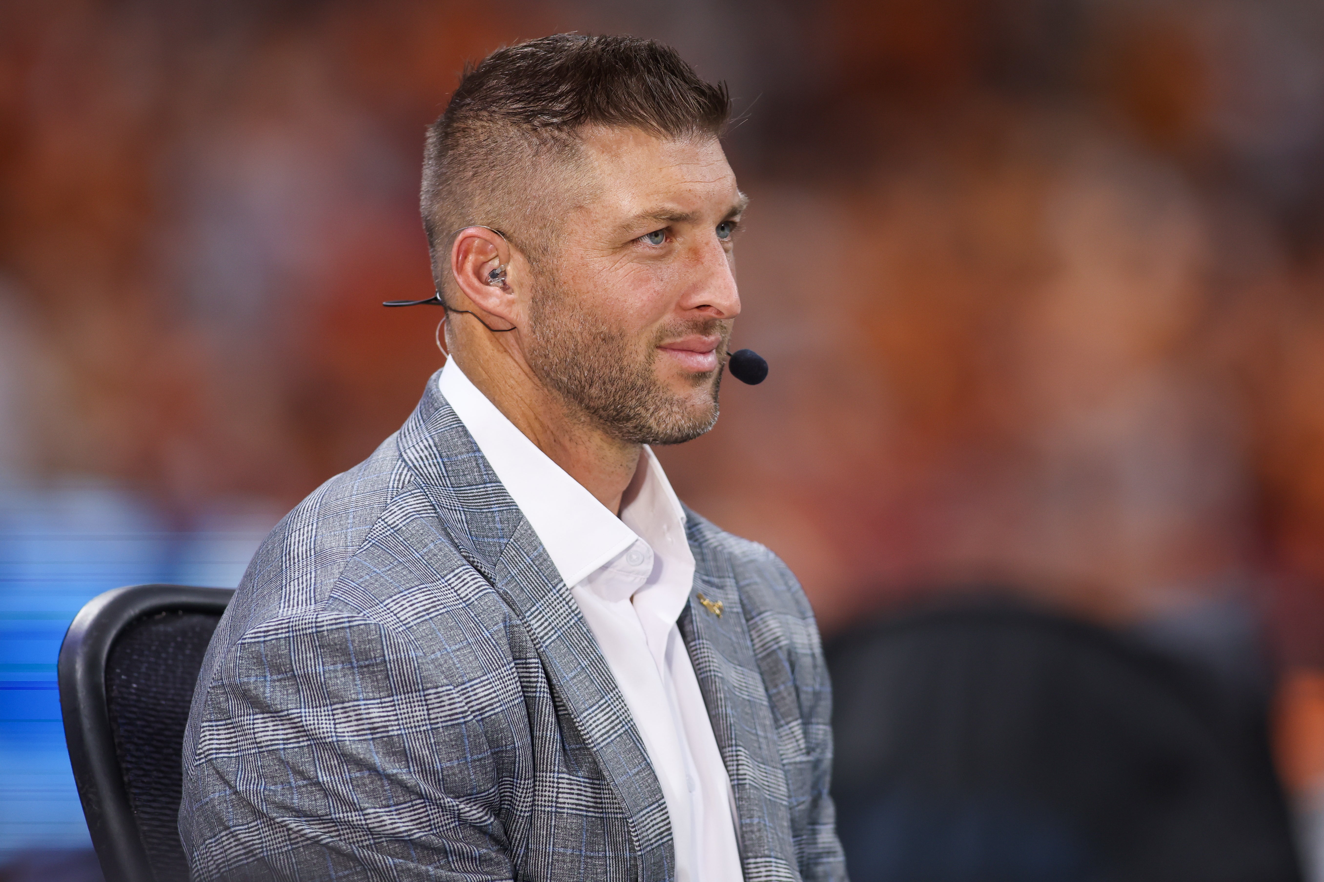 Aug 30, 2025; Atlanta, Georgia, USA; SEC Network analyst Tim Tebow on the field before a game between the Tennessee Volunteers and Syracuse Orange at Mercedes-Benz Stadium.