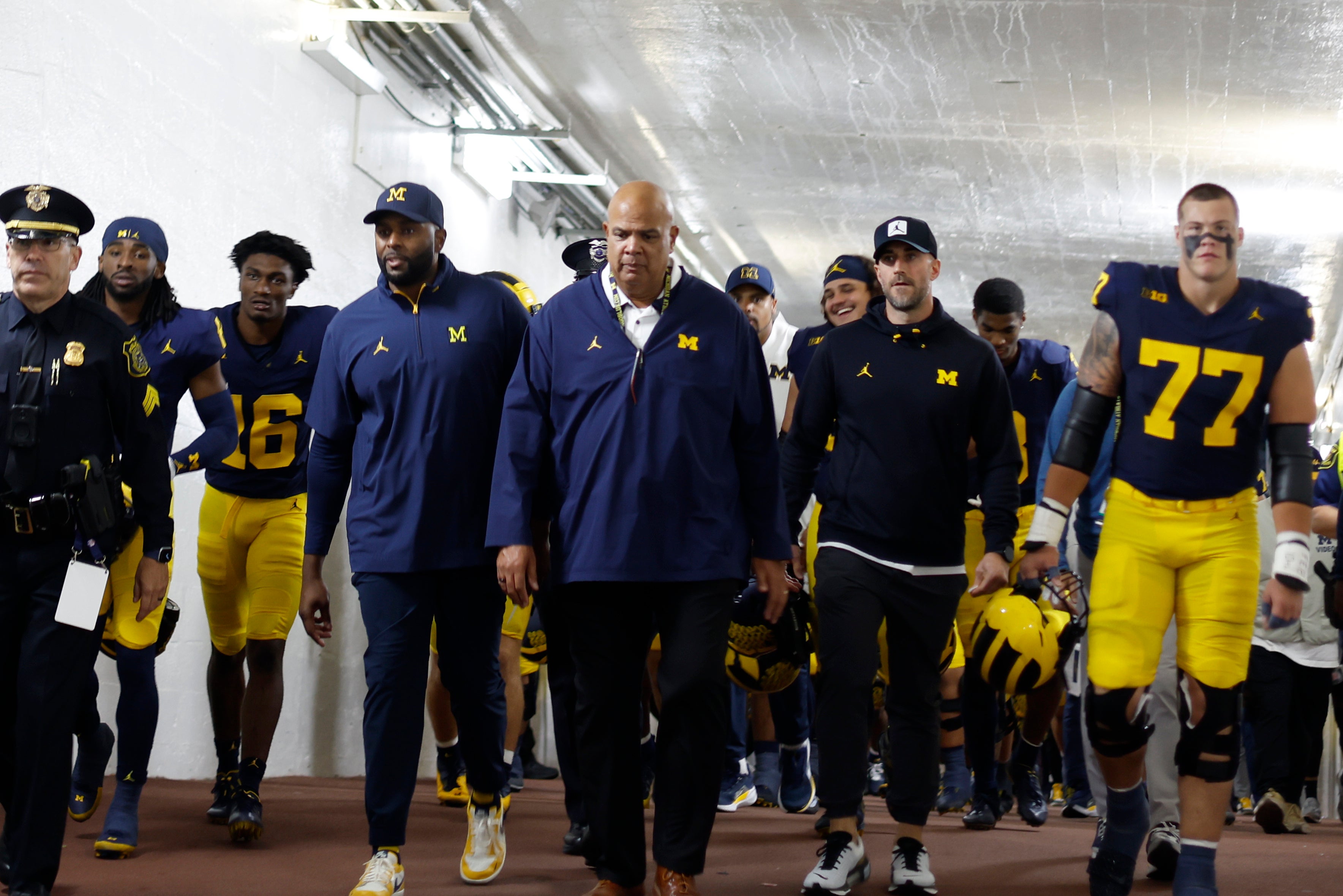Aug 30, 2025; Ann Arbor, Michigan, USA; Michigan Wolverines head coach Sherone Moore and Athletic Director Warde Manuel lead the team up the tunnel after the game against the New Mexico Lobos at Michigan Stadium.