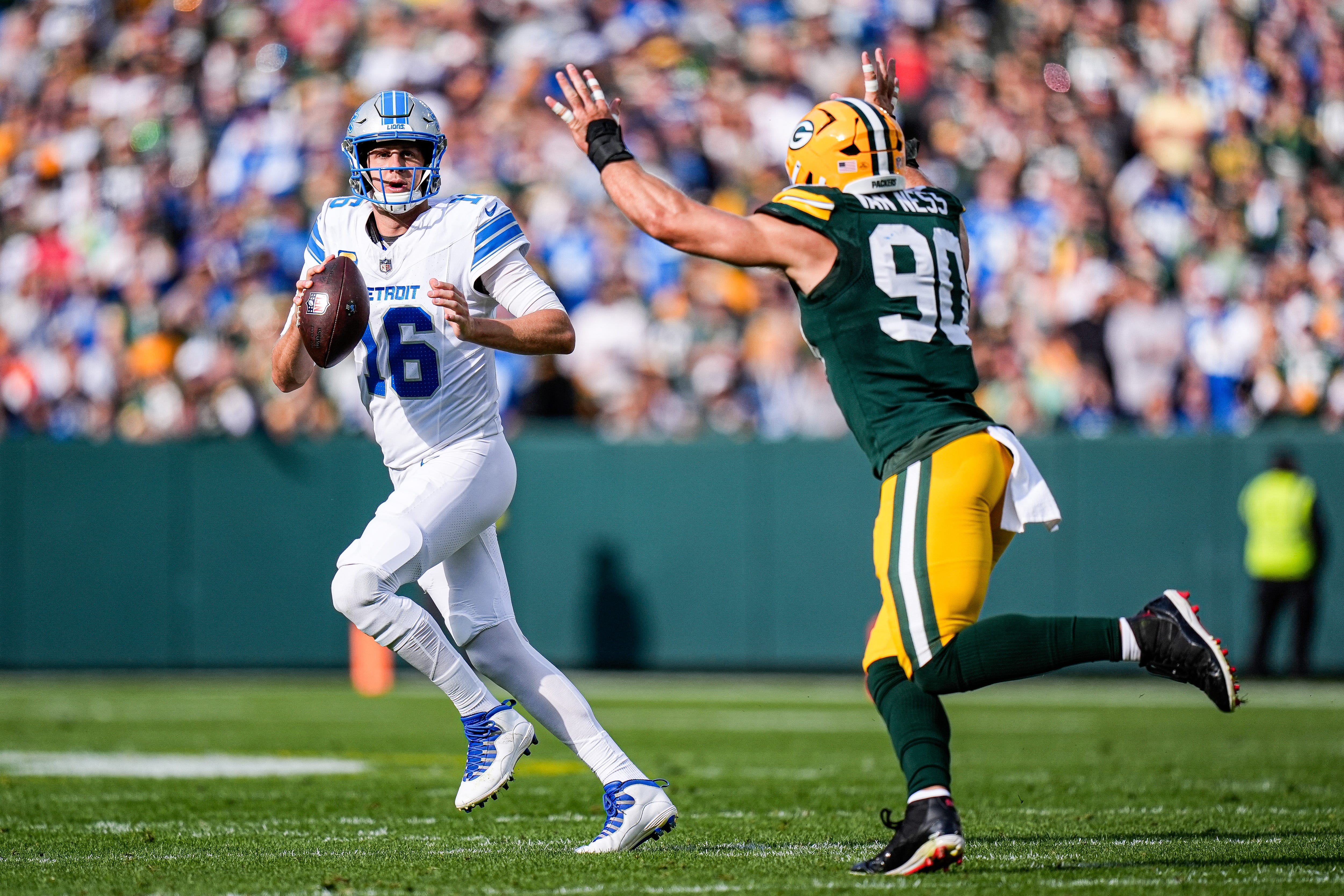Detroit Lions quarterback Jared Goff (16) looks to pass against Green Bay Packers defensive end Lukas Van Ness (90) during the first half at Lambeau Field in Green Bay, Wis., on Sunday, September 7, 2025.
