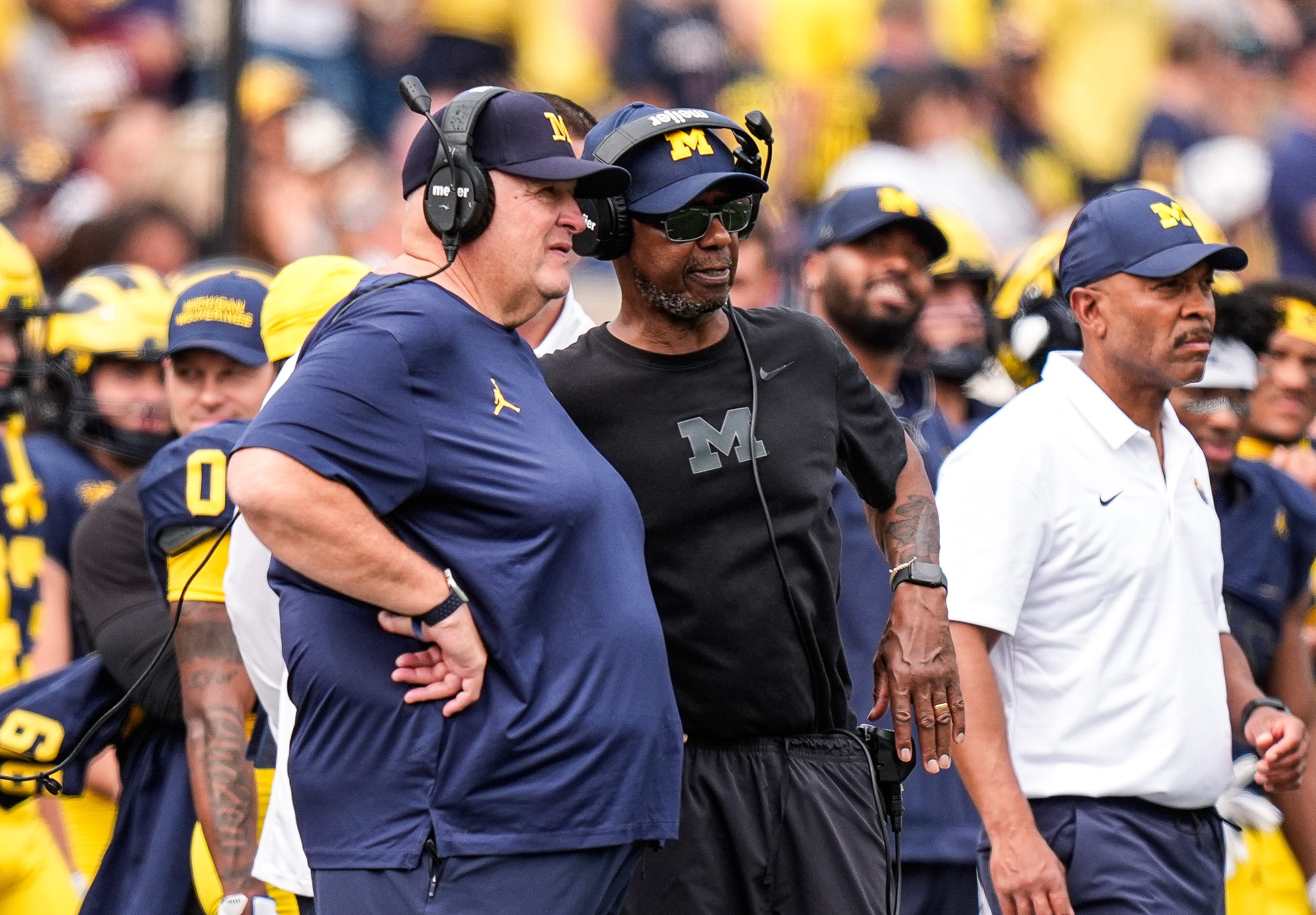 Michigan acting head coach Biff Poggi talks to senior offensive analyst Fred Jackson during the second half against Central Michigan at Michigan Stadium in Ann Arbor on Saturday, Sept. 13, 2025.
