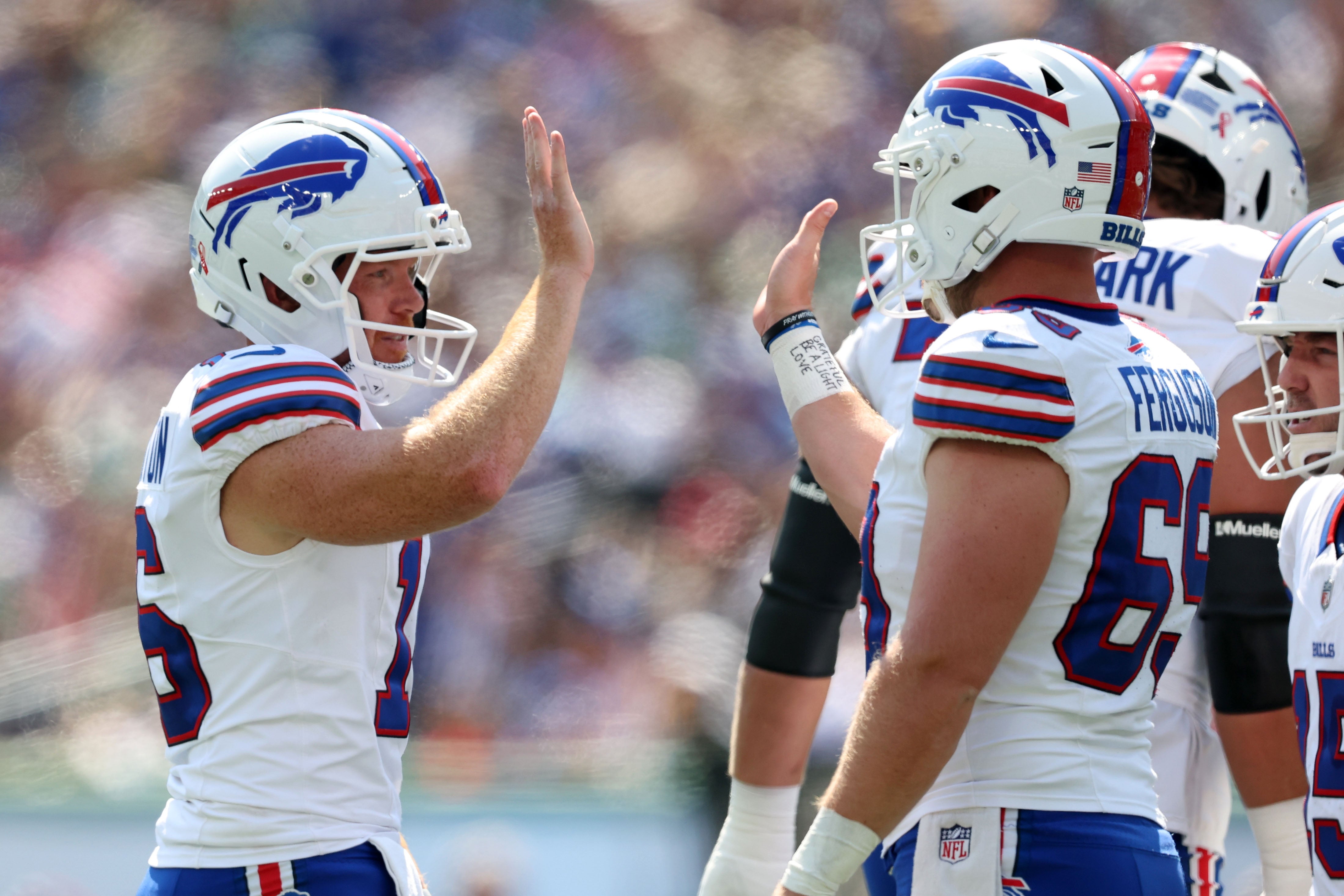 Sep 14, 2025; East Rutherford, New Jersey, USA; Buffalo Bills punter Cameron Johnston (16) reacts with long snapper Reid Ferguson (69) during the first half at MetLife Stadium.