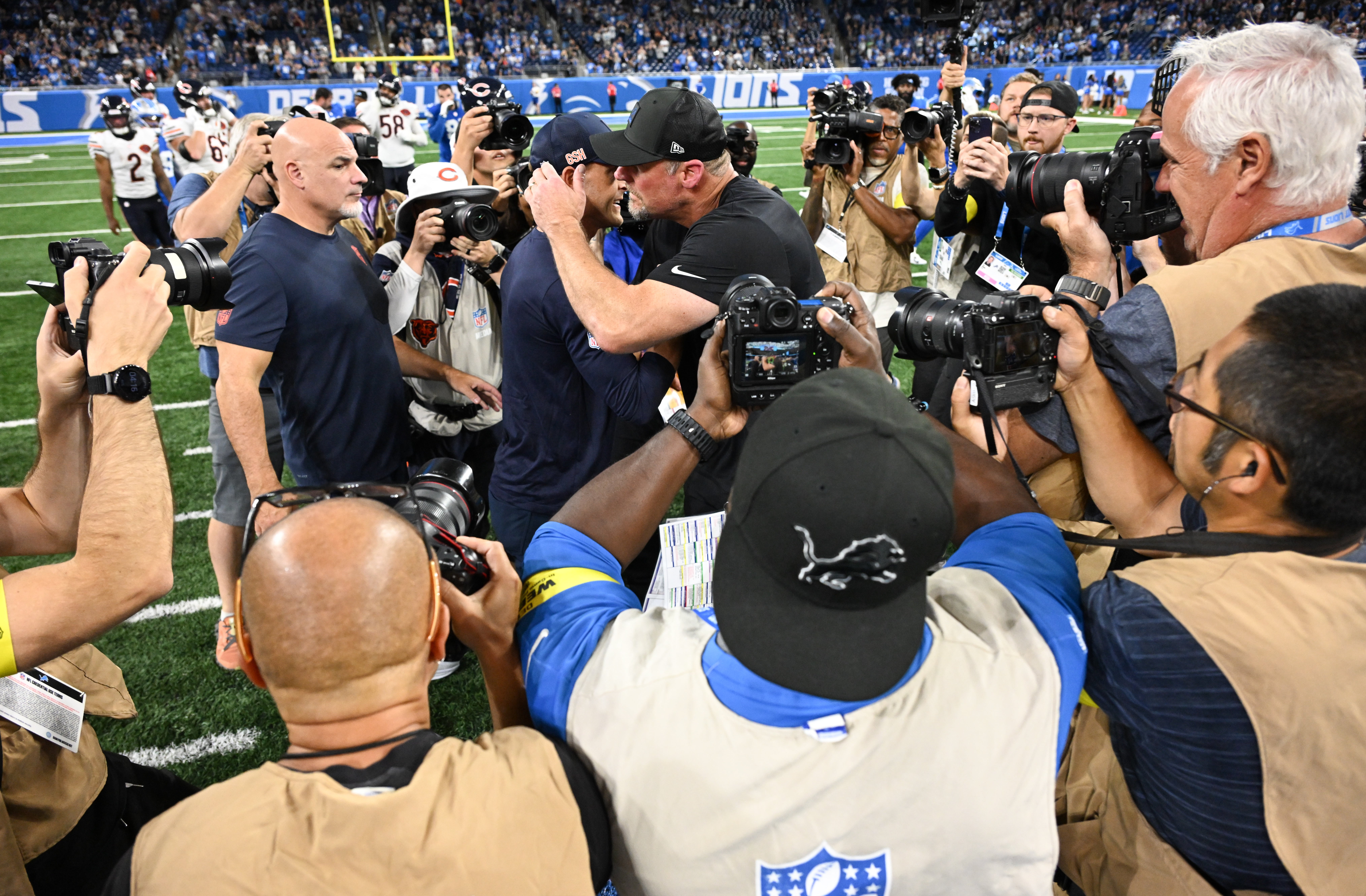 Sep 14, 2025; Detroit, Michigan, USA; Chicago Bears head coach Ben Johnson and Detroit Lions head coach Dan Campbell hug after the game at Ford Field.