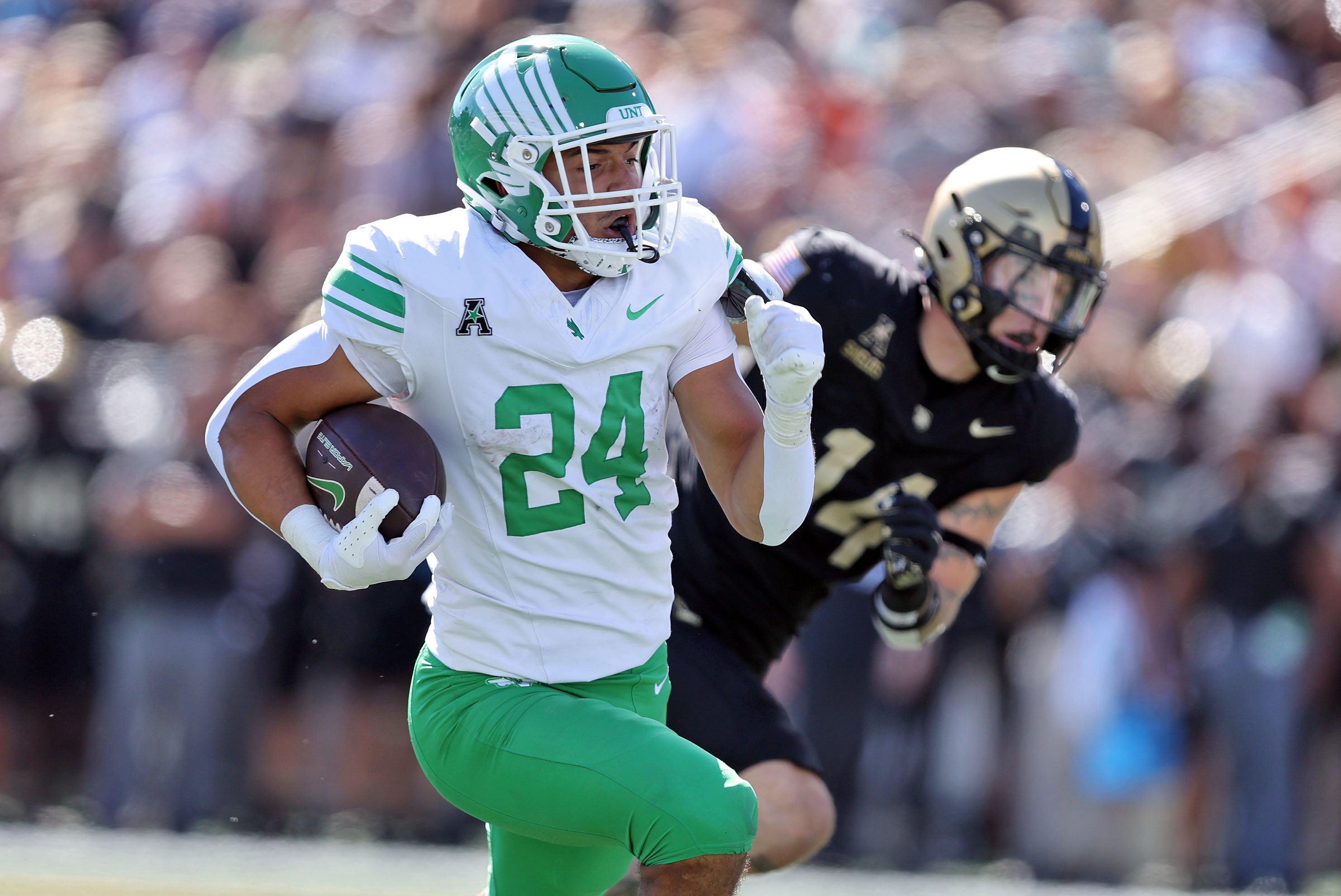 Sep 20, 2025; West Point, New York, USA; North Texas Mean Green running back Caleb Hawkins (24) runs for a touchdown against the Army Black Knights during the second half at Michie Stadium. Mandatory Credit: Danny Wild-Imagn Images