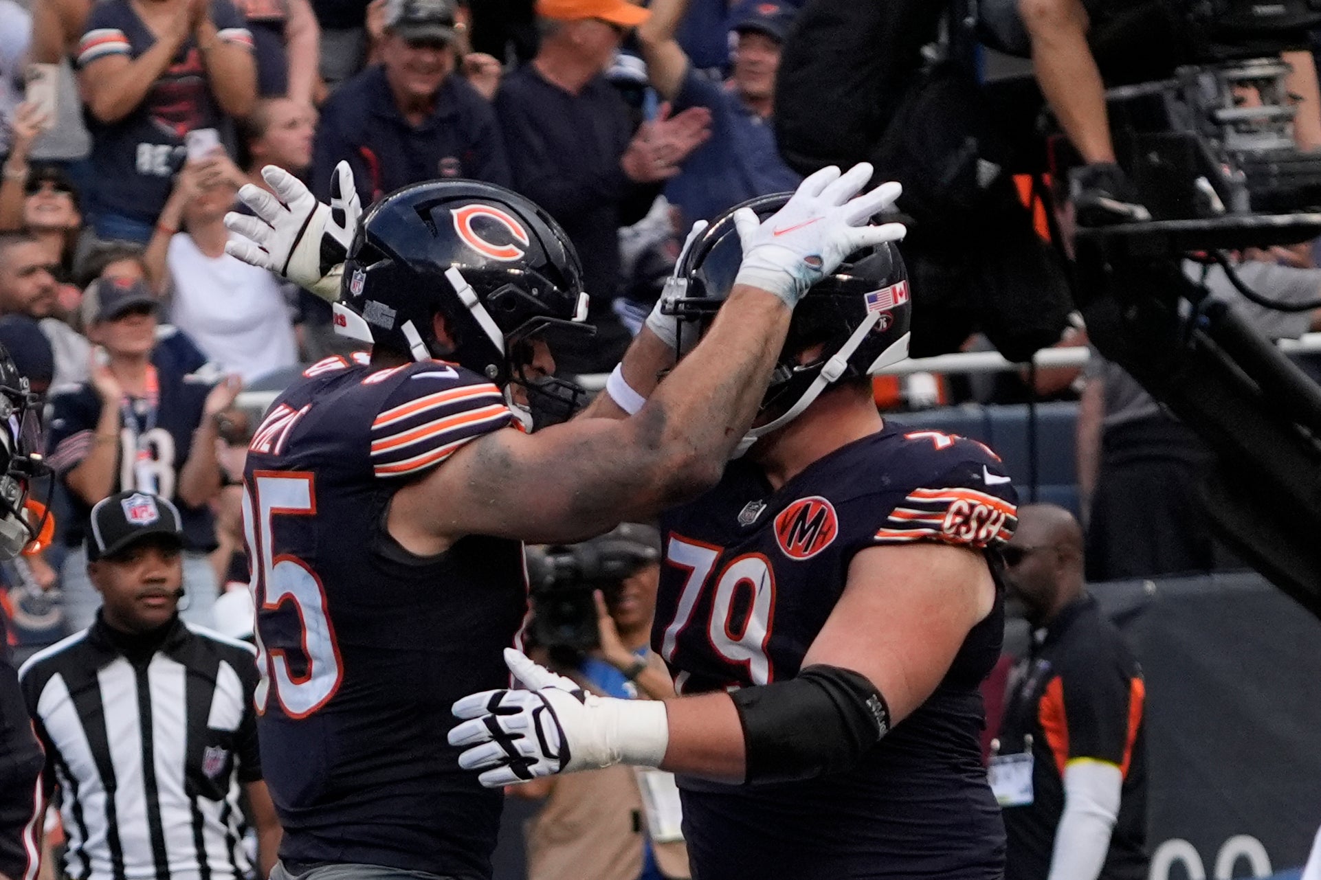 Sep 21, 2025; Chicago, Illinois, USA; Chicago Bears tight end Cole Kmet (85) celebrates his touchdown reception against the Dallas Cowboys with Chicago Bears offensive lineman Theo Benedet (79) during the first half at Soldier Field.