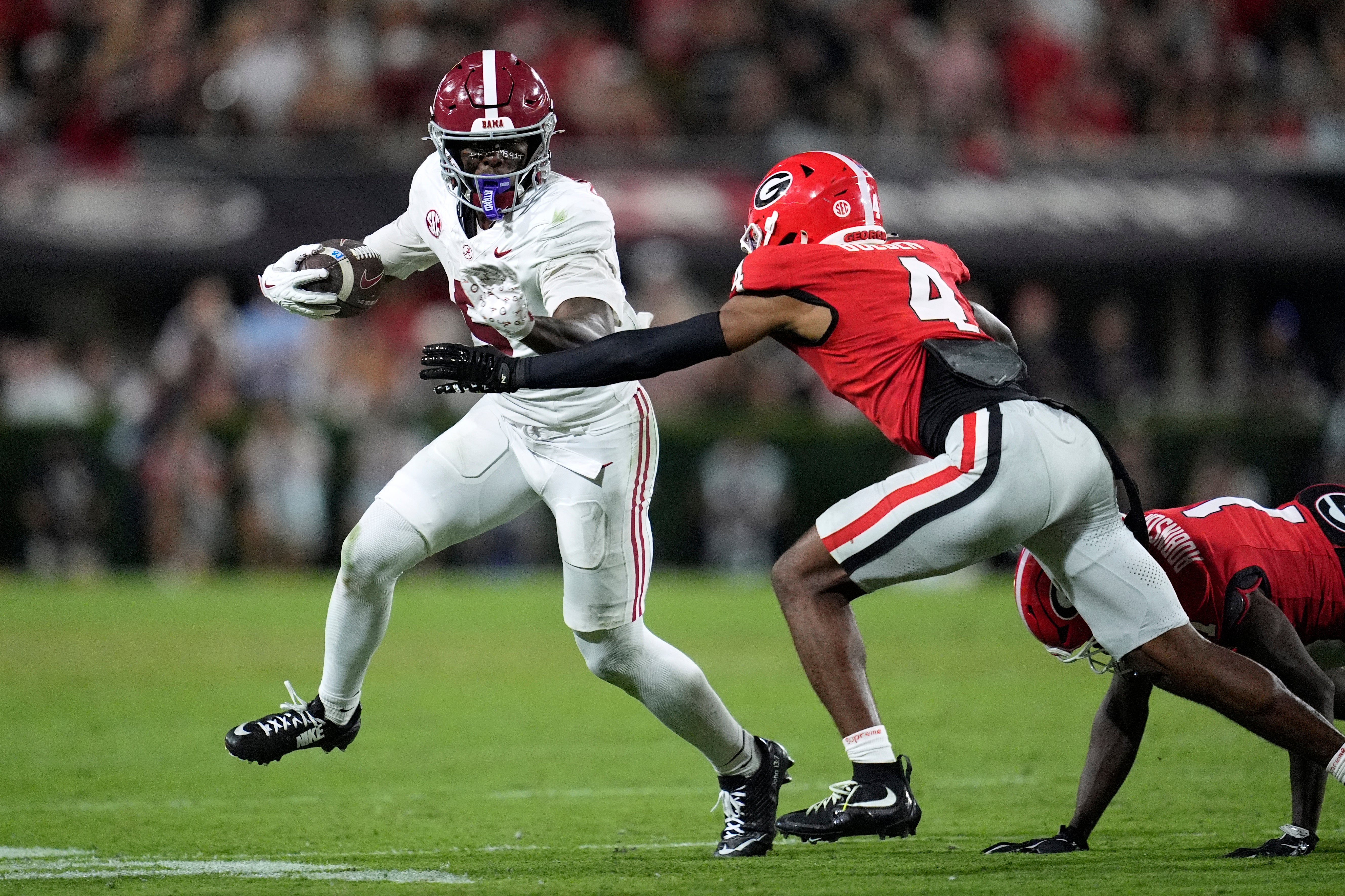 Sep 27, 2025; Athens, Georgia, USA; Alabama Crimson Tide wide receiver Germie Bernard (5) runs against Georgia Bulldogs defensive back Ellis Robinson IV (1) and defensive back KJ Bolden (4) in the second half at Sanford Stadium.