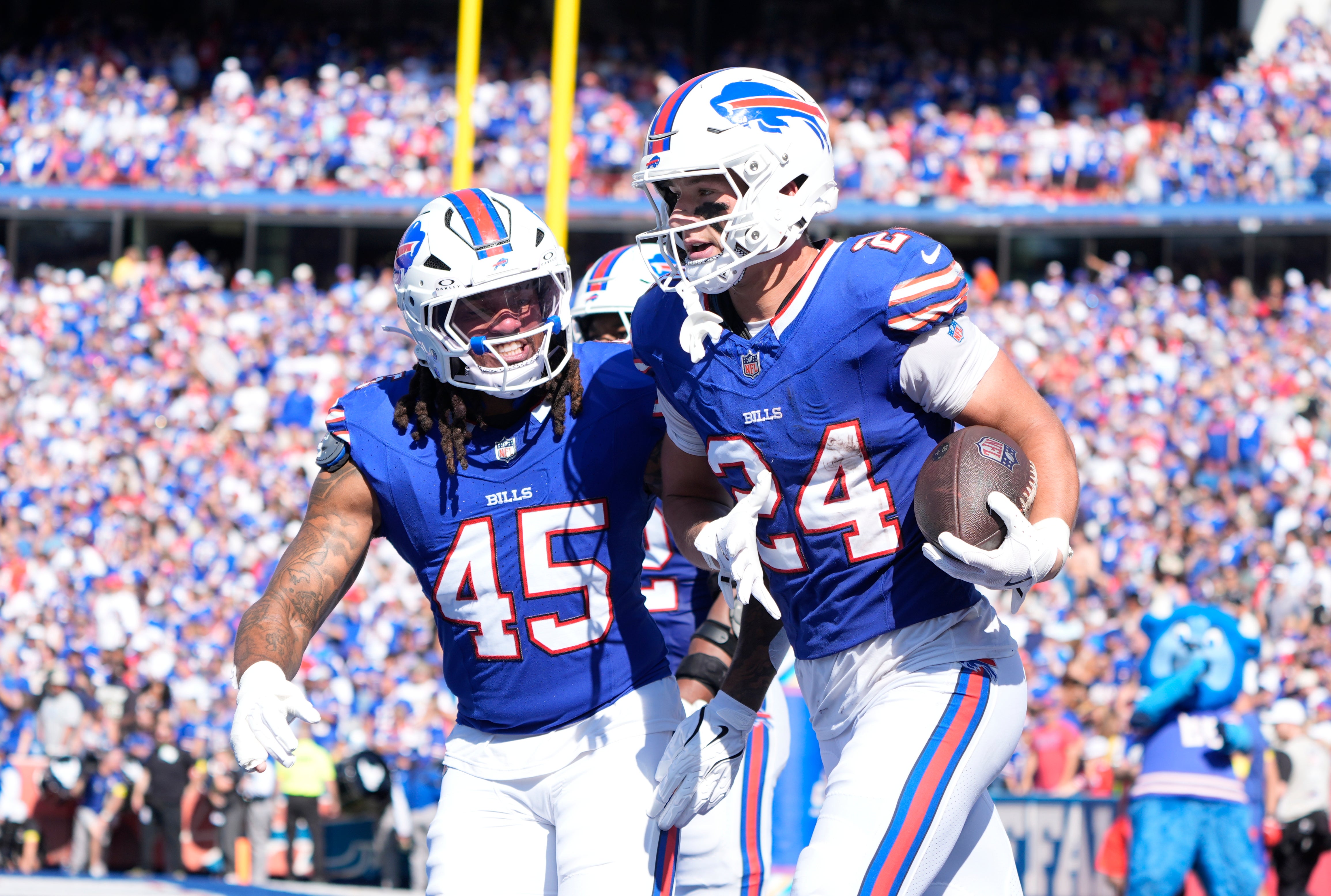 Sep 28, 2025; Orchard Park, New York, USA; Buffalo Bills safety Cole Bishop (24) and outside linebacker Shaq Thompson (45) celebrate after intercepting a pass intended for New Orleans Saints quarterback Spencer Rattler (2) during the second quarter at Highmark Stadium.