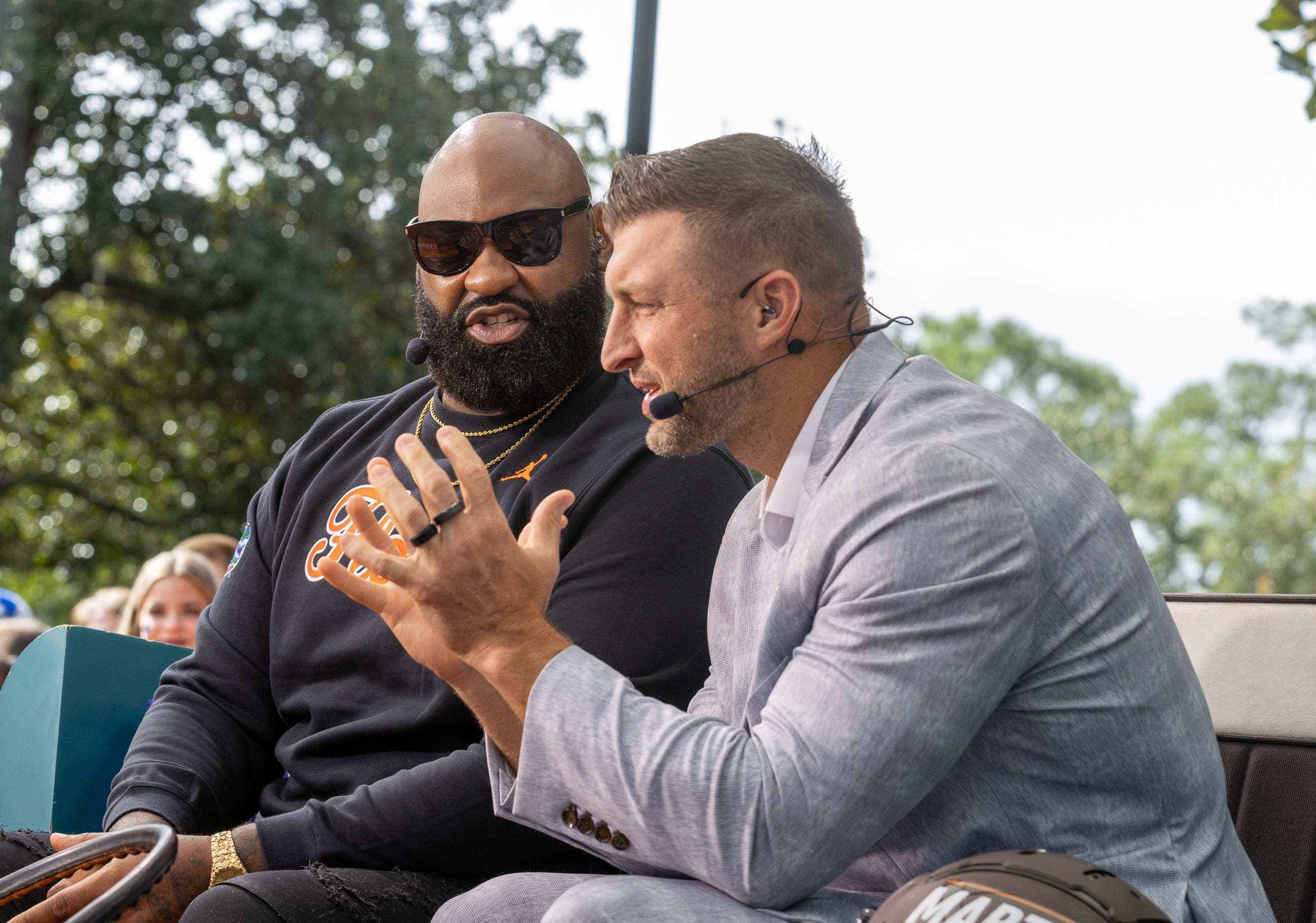 Former Gators Brandon Spikes, left, and Tim Tebow make an appearance on Marty and McGee as they do their show from Plaza of the Americas in Gainesville, FL on Saturday, October 4, 2025. [Alan Youngblood/Gainesville Sun]