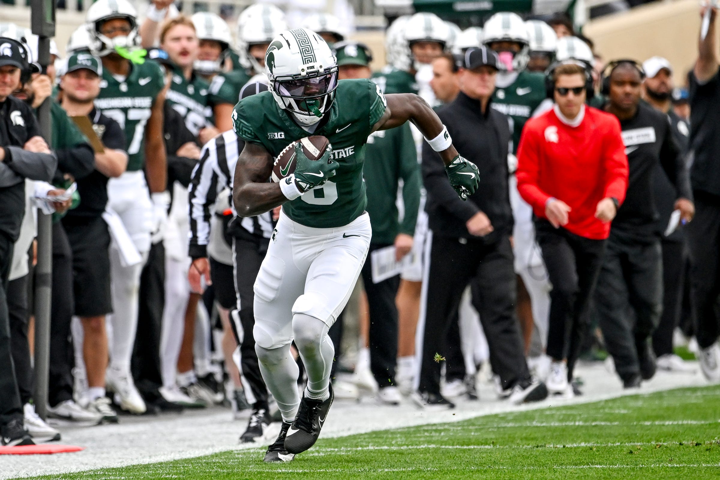 Michigan State's Nick Marsh, left, runs after a catch against UCLA during the first quarter on Saturday, Oct. 11, 2025, at Spartan Stadium in East Lansing.