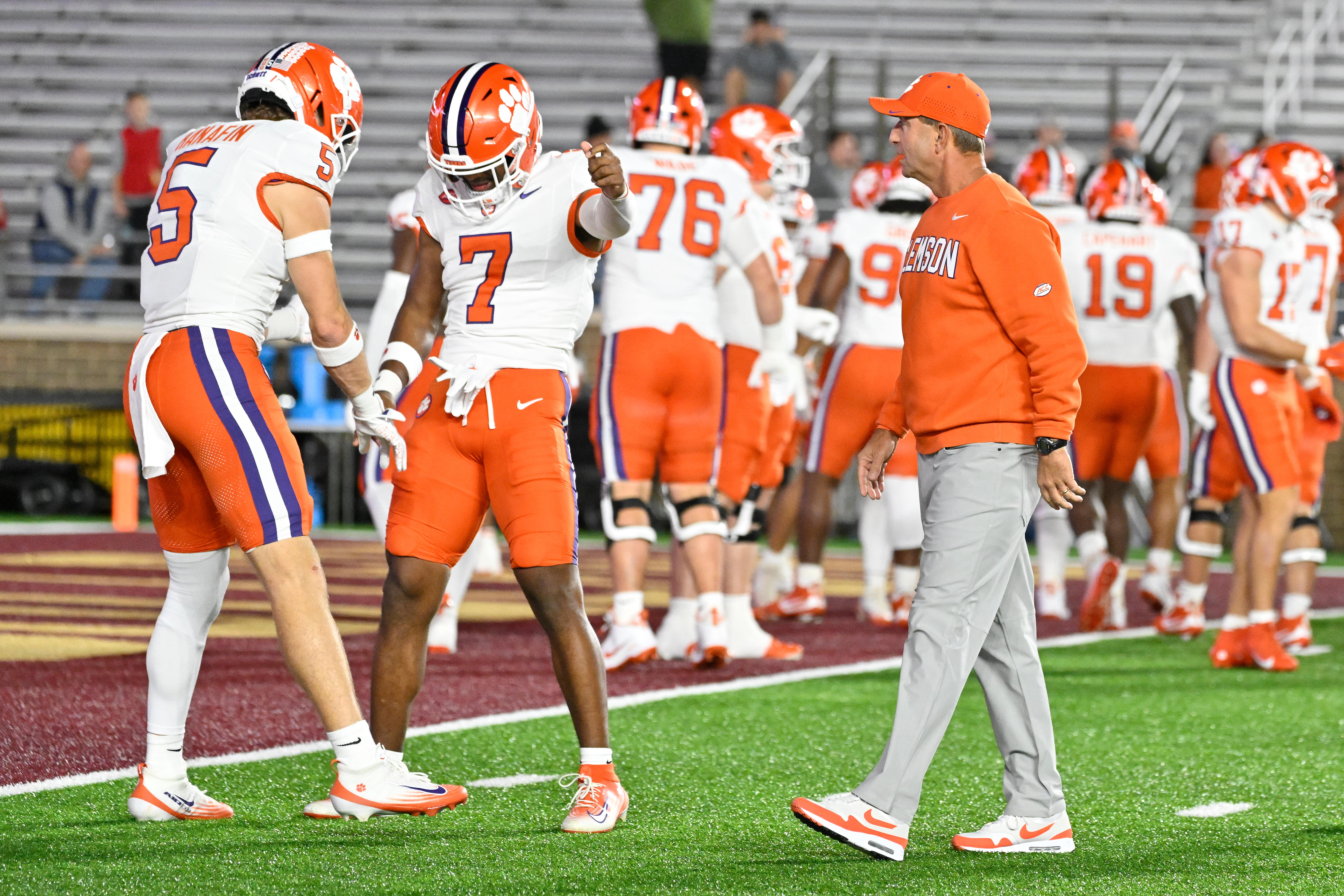 Oct 11, 2025; Chestnut Hill, Massachusetts, USA; Clemson Tigers head coach Dabo Swinney (l) talks to safety Ronan Hanafin (5) and safety Khalil Barnes (7) before a game against the Boston College Eagles at Alumni Stadium. Mandatory Credit: Eric Canha-Imagn Images