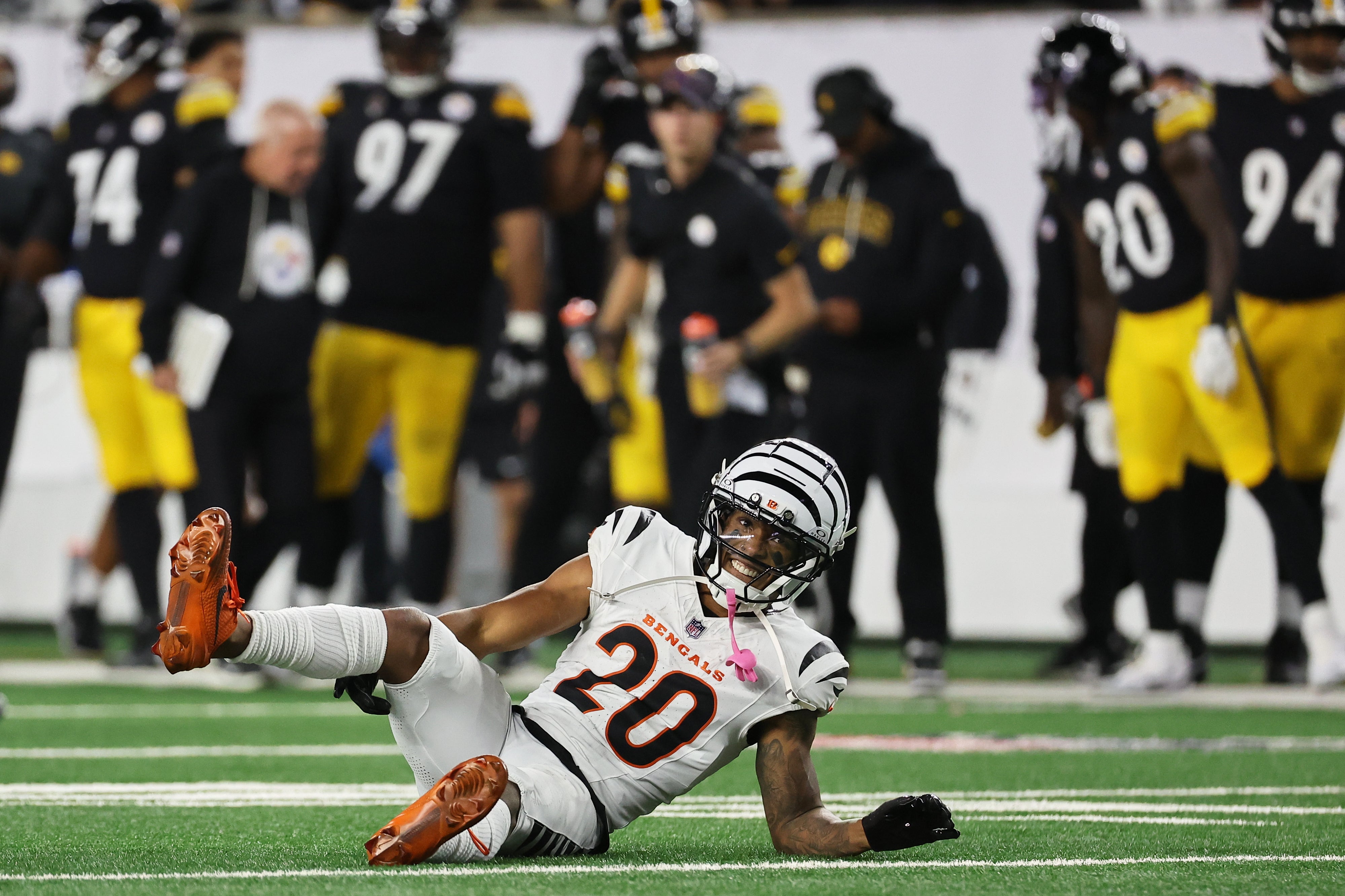 Oct 16, 2025; Cincinnati, Ohio, USA; Cincinnati Bengals cornerback DJ Turner II (20) lies on the field with an apparent injury against the Pittsburgh Steelers during the third quarter at Paycor Stadium.