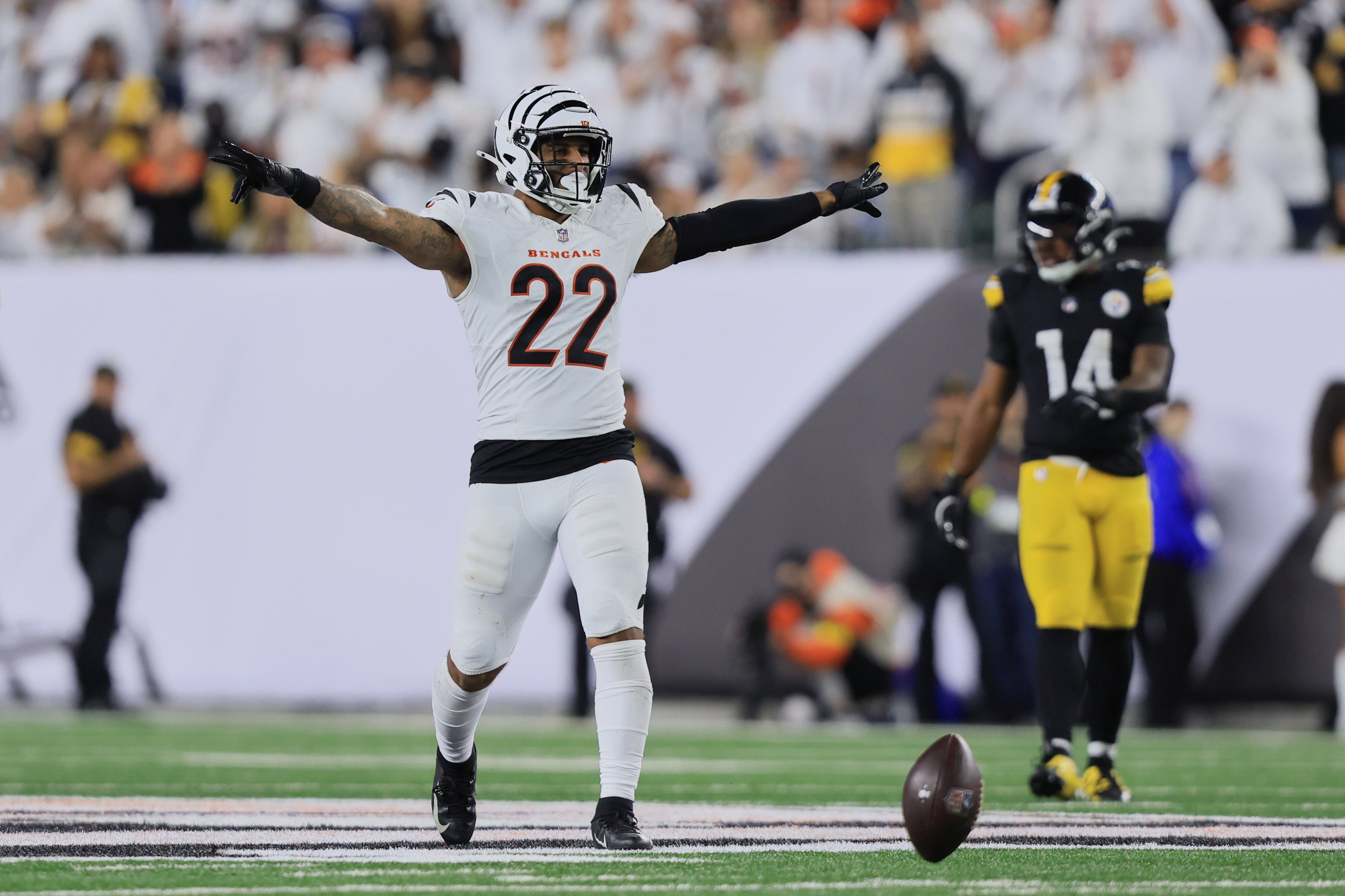 Oct 16, 2025; Cincinnati, Ohio, USA; Cincinnati Bengals safety Geno Stone (22) reacts and Pittsburgh Steelers running back Kenneth Gainwell (14) looks on during the fourth quarter at Paycor Stadium.