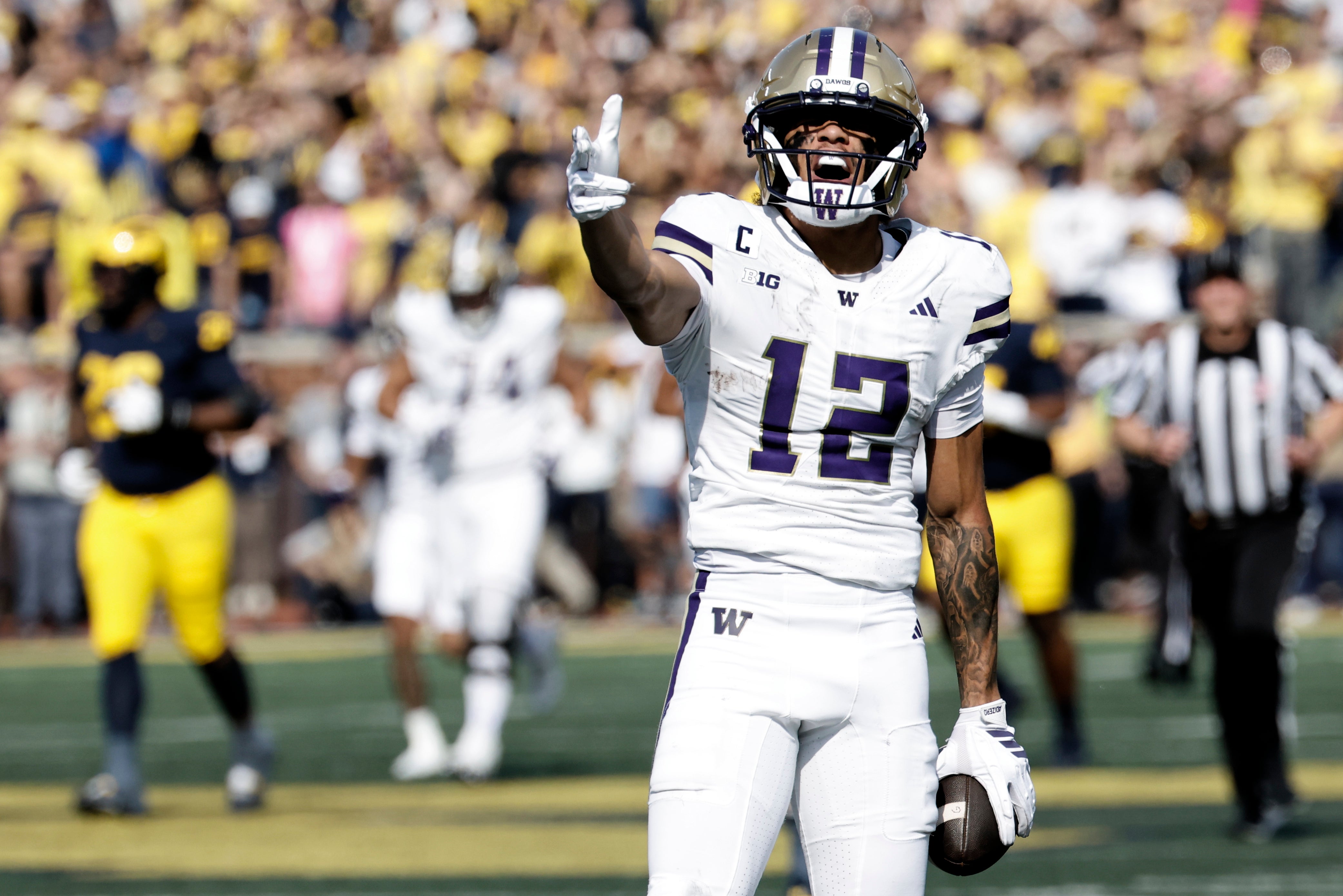 Oct 18, 2025; Ann Arbor, Michigan, USA; Washington Huskies wide receiver Denzel Boston (12) celebrates after he makes a reception in the first half against the Michigan Wolverines at Michigan Stadium. Mandatory Credit: Rick Osentoski-Imagn Images