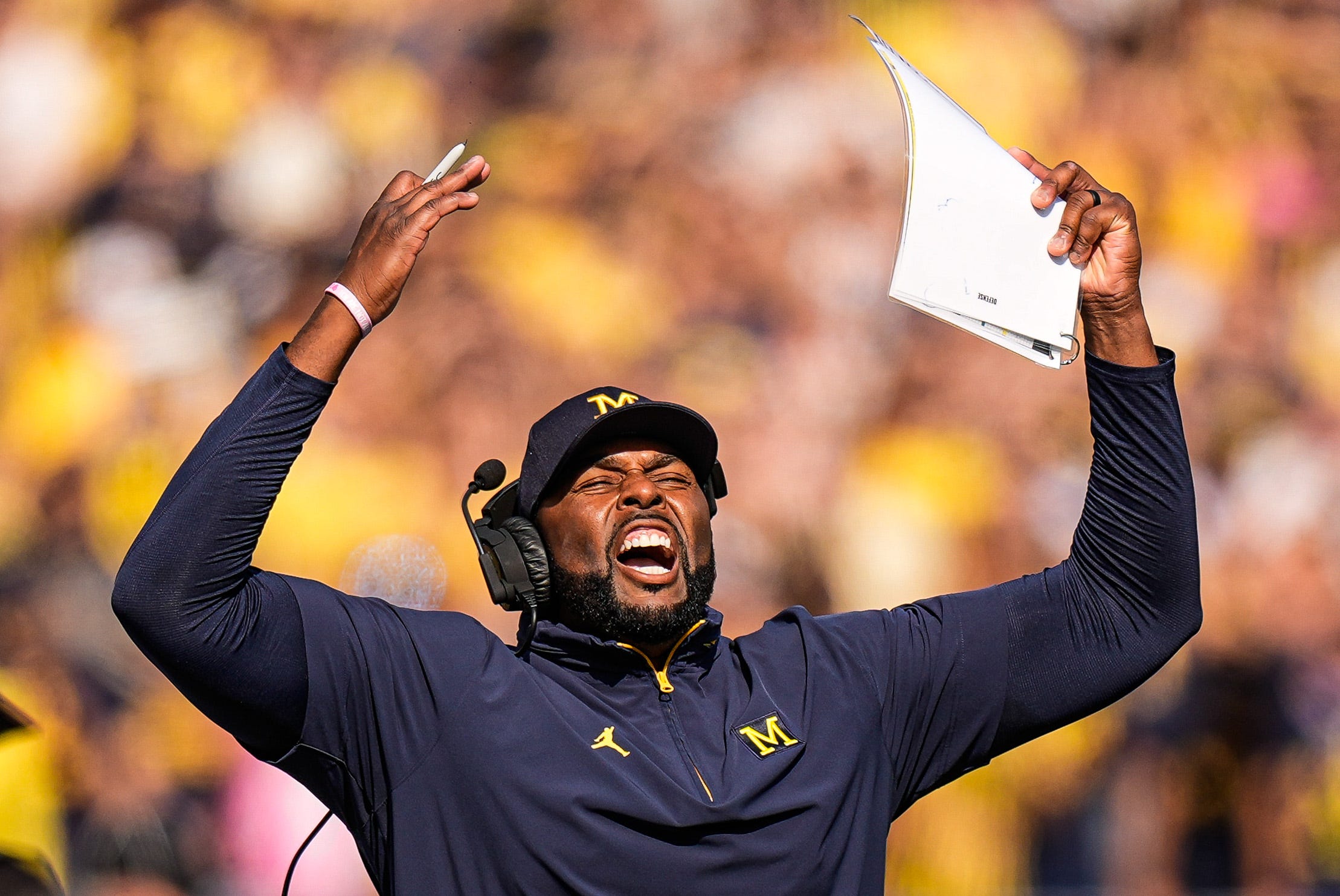 Michigan head coach Sherrone Moore cheers on before a play against Washington during the first half at Michigan Stadium in Ann Arbor on Saturday, Oct. 18, 2025.