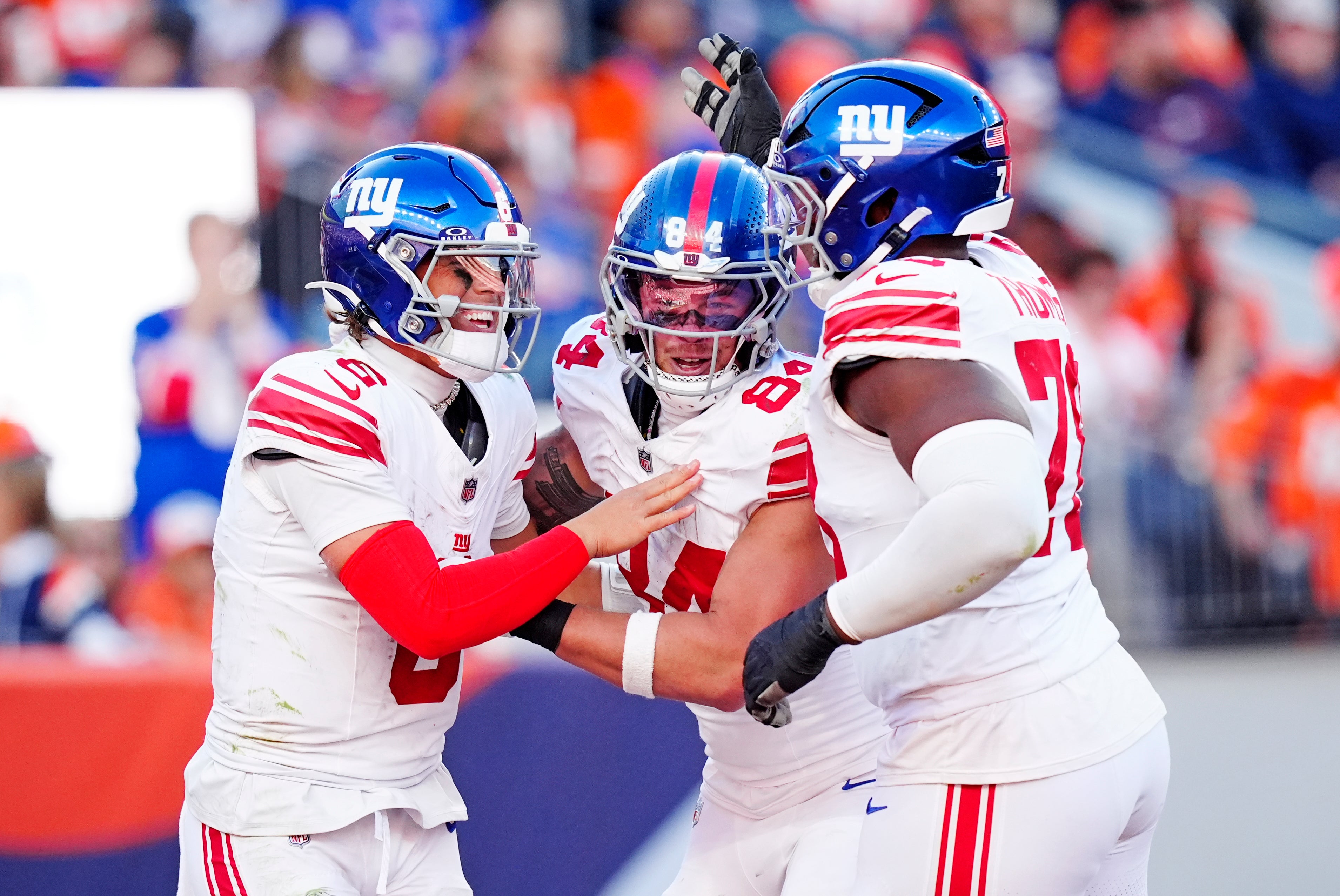 Oct 19, 2025; Denver, Colorado, USA; New York Giants quarterback Jaxson Dart (6), New York Giants tight end Theo Johnson (84) and New York Giants offensive tackle Andrew Thomas (78) react after a play during the second half against the Denver Broncos at Empower Field at Mile High.