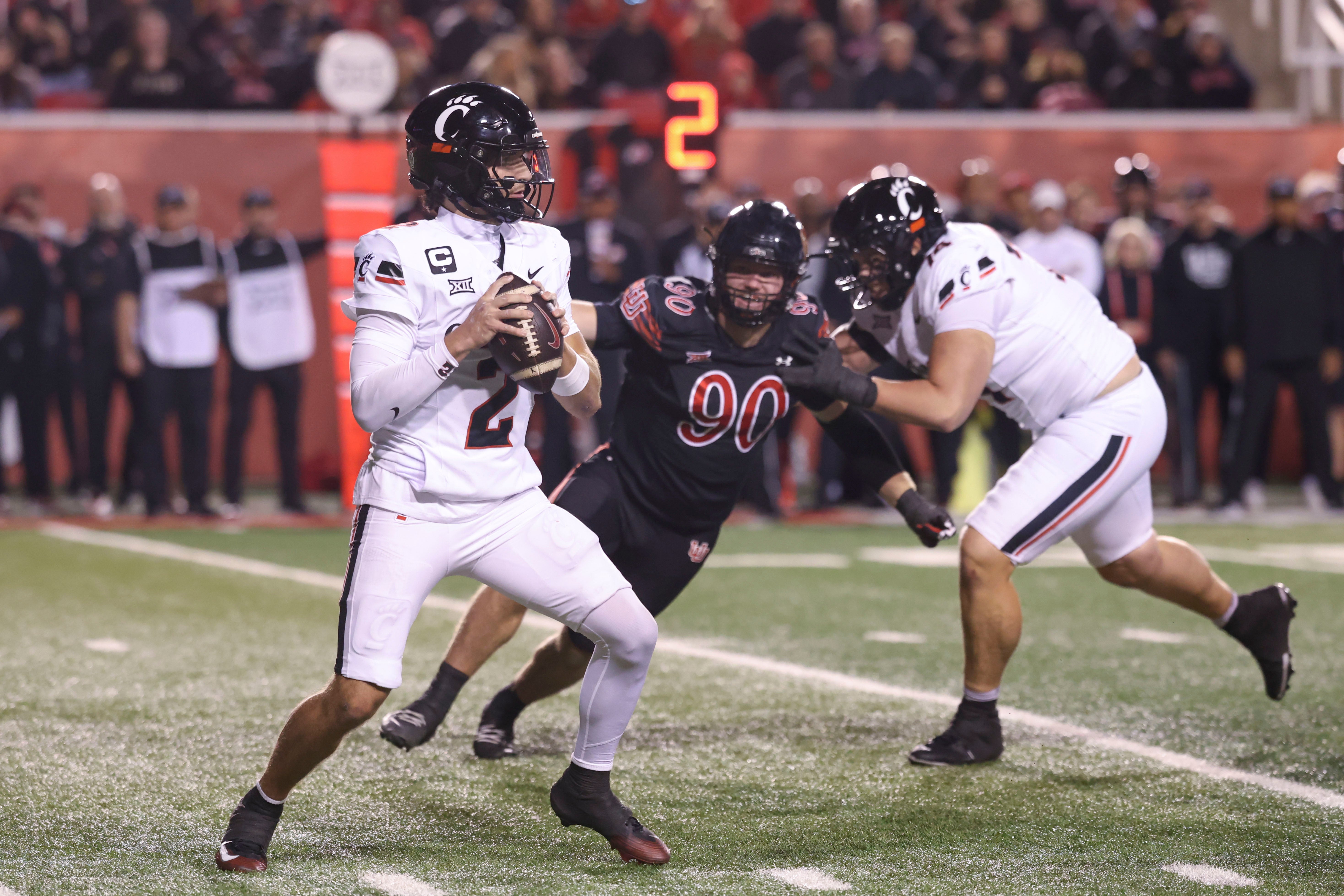 Nov 1, 2025; Salt Lake City, Utah, USA; Cincinnati Bearcats quarterback Brendan Sorsby (2) looks to pass against Utah Utes defensive end John Henry Daley (90) during the second half at Rice-Eccles Stadium. Mandatory Credit: Rob Gray-Imagn Images