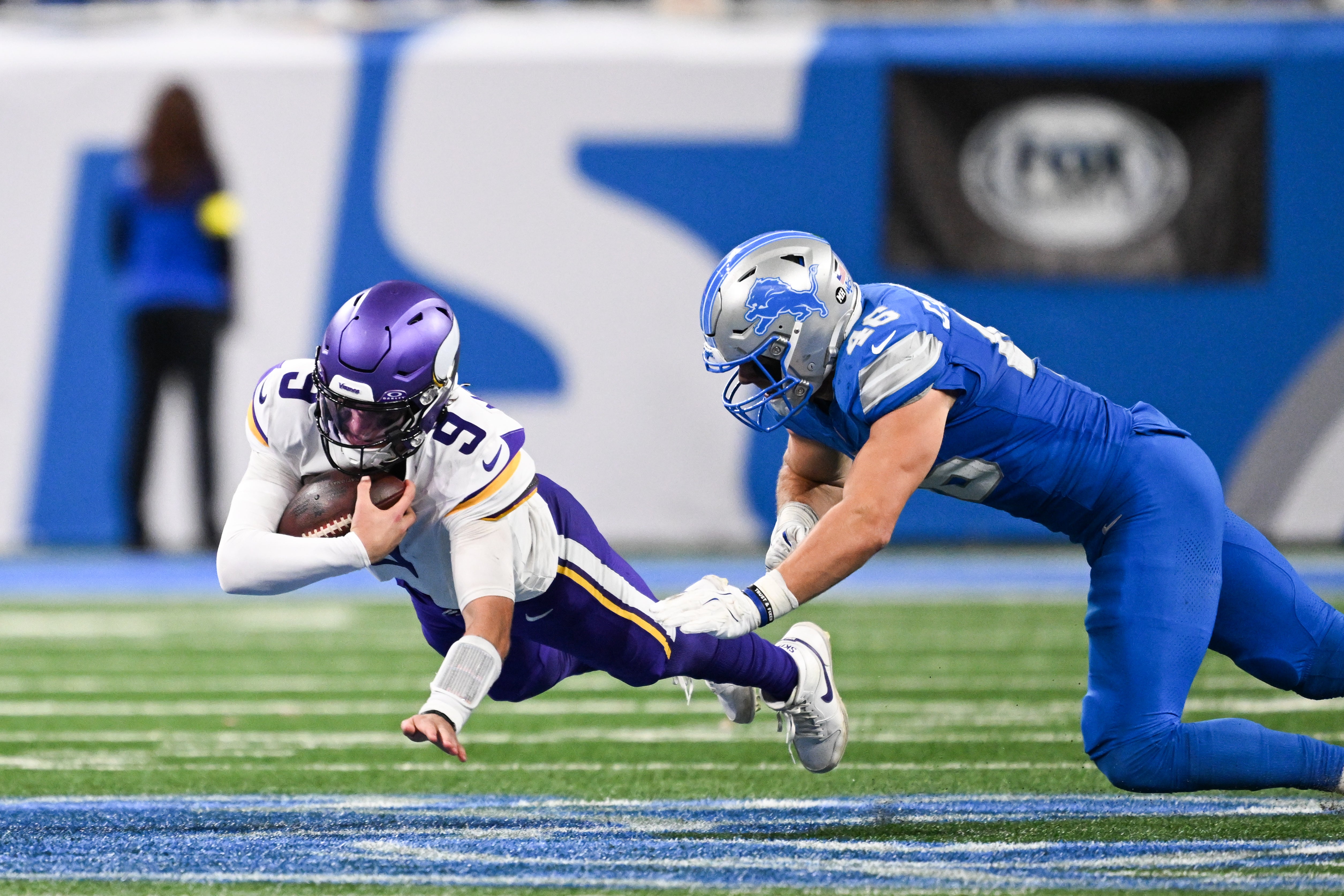 Nov 2, 2025; Detroit, Michigan, USA; Minnesota Vikings quarterback J.J. McCarthy (9) dives forward after scrambling out of the pocket in the third quarter against the Detroit Lions at Ford Field.